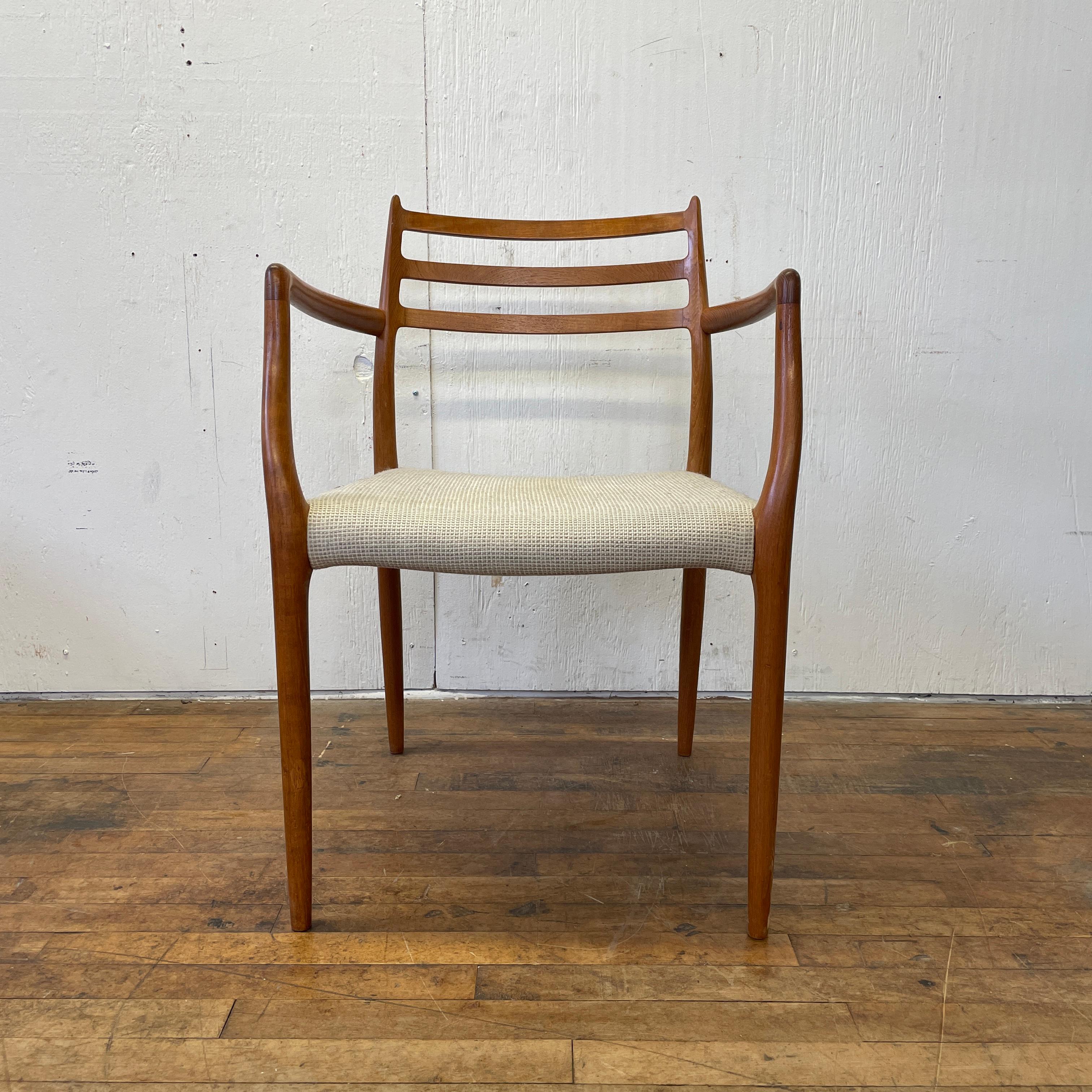 Among the most stylish and iconic chairs that money can buy, this Model #62 Scandinavian armchair by Niels Otto Moller is a midcentury Danish modern Classic. With a soft upholstered seat and a sinuous teak wood frame, this chair will add comfort and