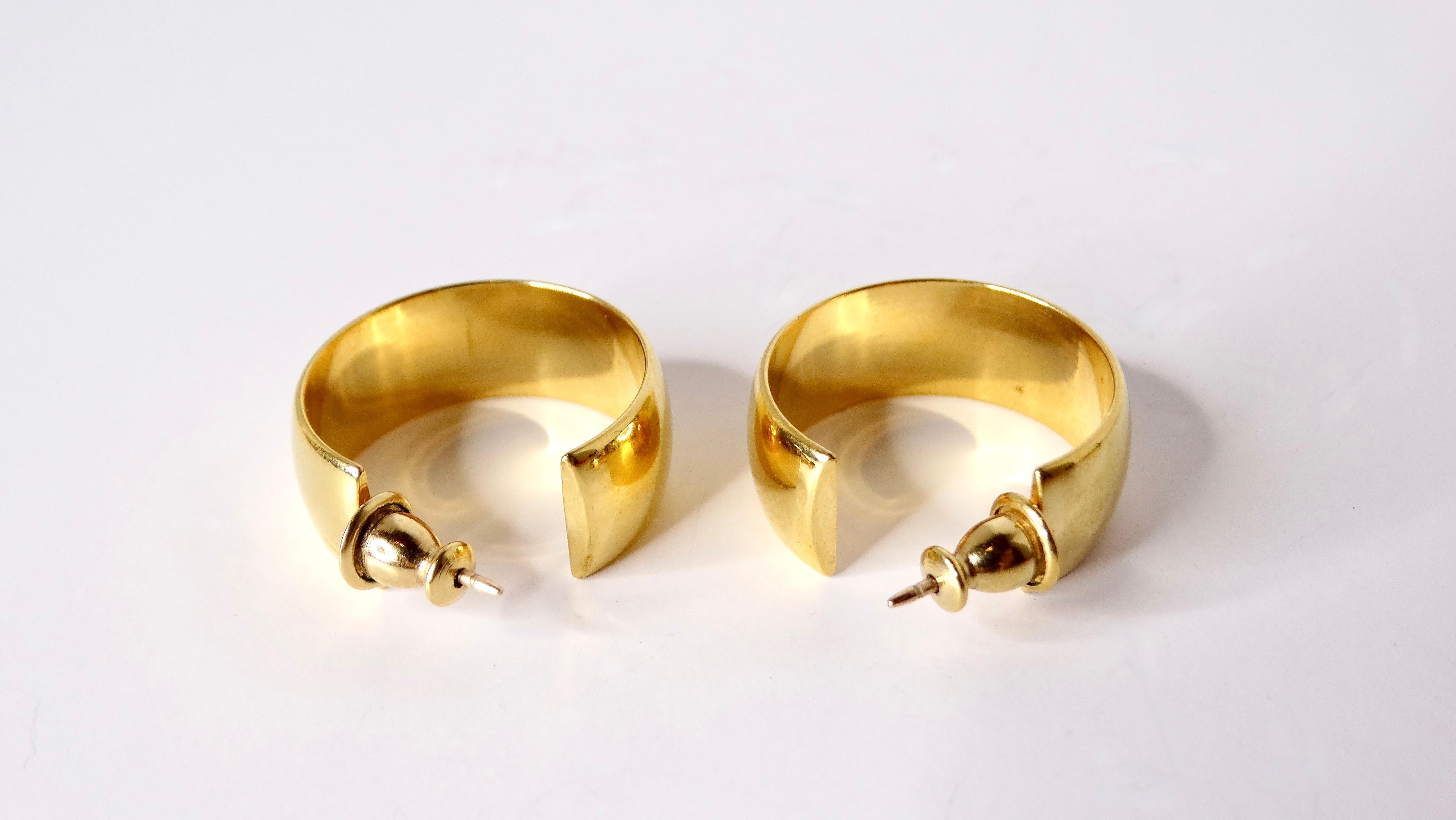 Elevate your accessory game with these Vintage Monet 18k Gold Plated Small Hoop Earrings. Perfectly sized for versatile styling, these exquisite hoops radiate timeless elegance and sophistication. The lustrous 18k gold plating captures light