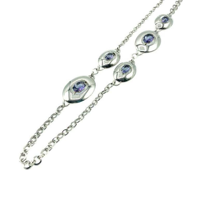 A super stylish Vintage Monet Amethyst Necklace. Crafted in high shine rhodium plated metal, set with large claw set amethyst glass faceted stones. In very good vintage condition, signed, 93cms. A beautifully styled bracelet from Monet that is both