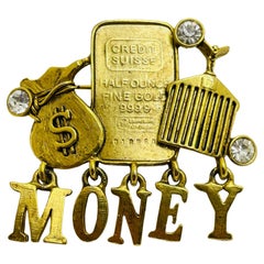 Vintage MONEY gold tone bar rhinestone designer runway brooch 