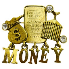 Vintage MONEY gold tone bar rhinestone designer runway brooch