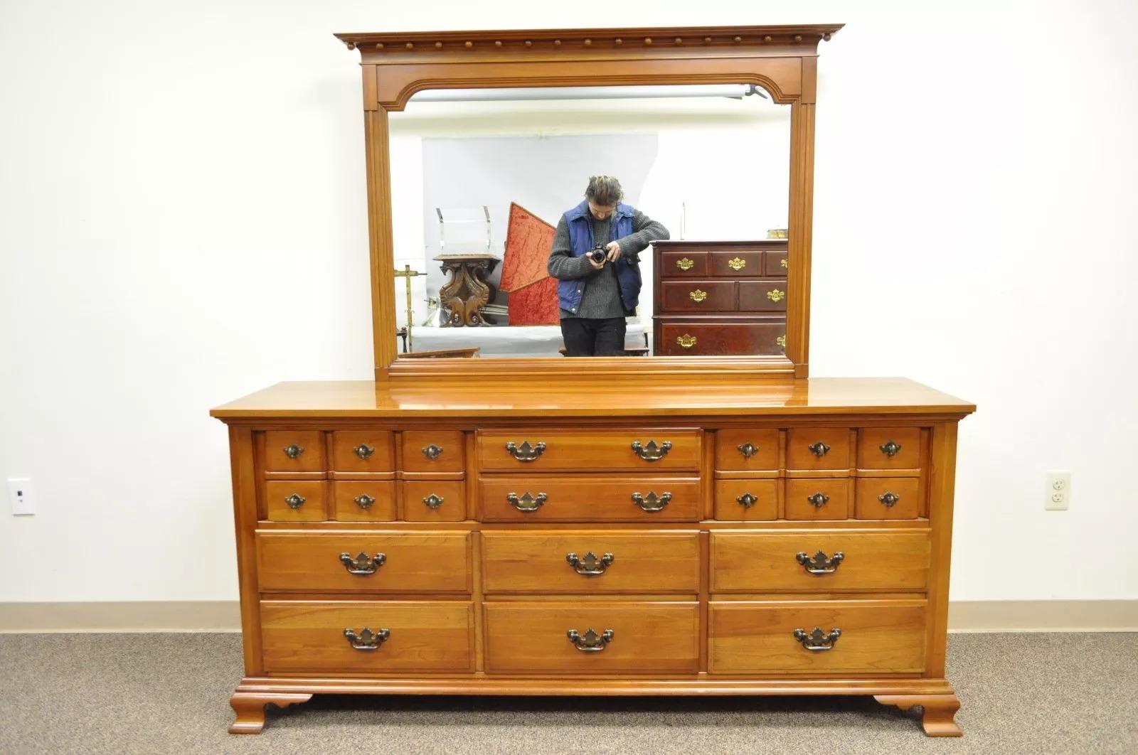 Vintage Solid Cherry Wood Long Dresser with Matching Mirror by Monitor American Emblem. Item features heavy solid cherry wood construction, 12 dovetail constructed drawers, matching mirror, traditional colonial form, great quality American made