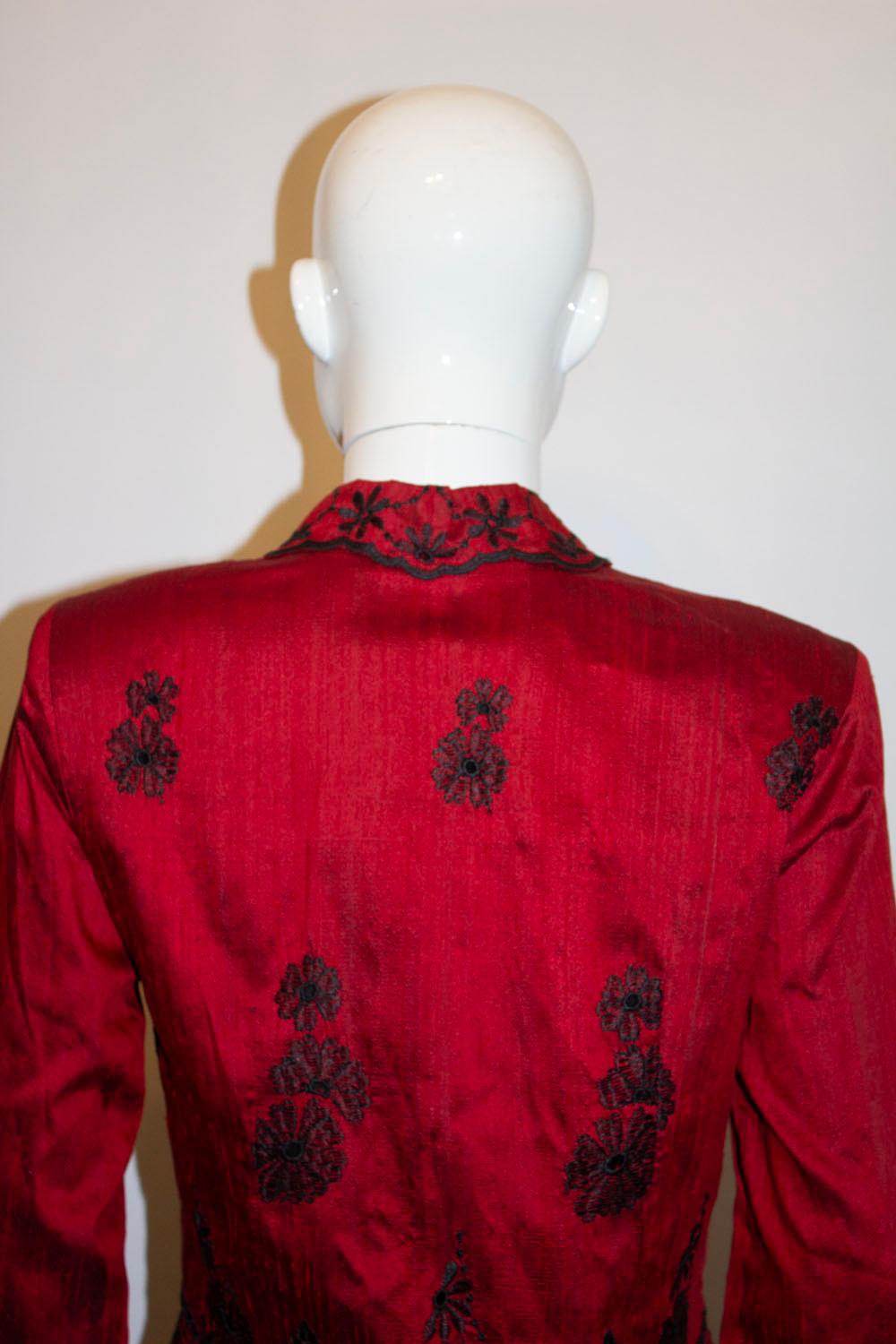 A stunning vintage silk jacket by Monsoon, Twillight line. In a wonderful dep red raw silk , the jacket has wonderful black silk embroidery on the front , back and cuffs. It has a cut away collar, a five button front opening and is fully lined. 
UK