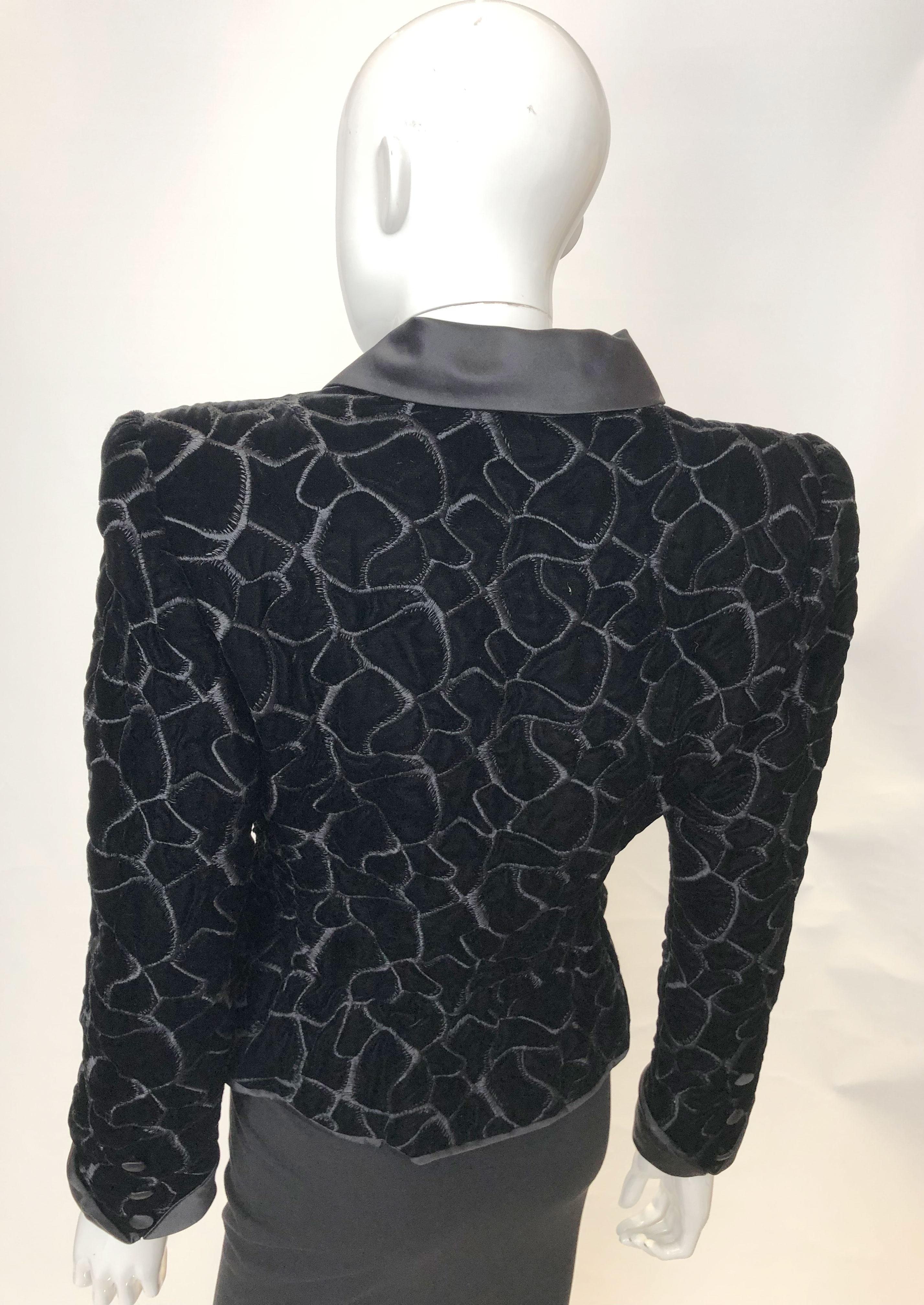 A head turning jacket by Monteverdi Couture. The jacket is in black velvet with interesting stitch detail. It has a satin collar and covered buttons. It is fully lined and has a peplum detail at the waist.