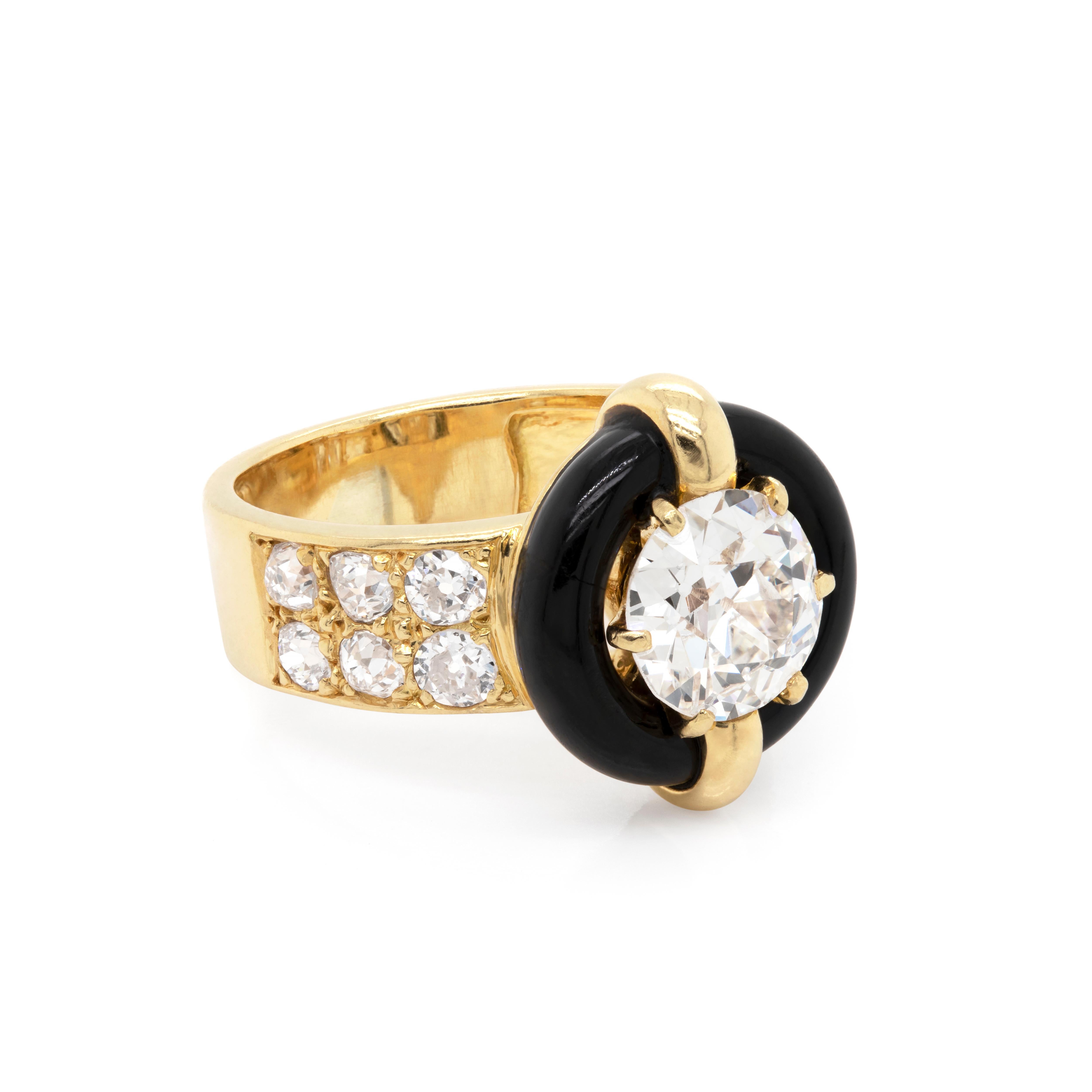 Vintage one of a kind target Mauboussin ring set with a 1.84 carat round old cut diamond in a six claw open back setting, mounted in the centre of a black onyx ring. The band is then grain set with six old cut diamonds on each shoulder with an