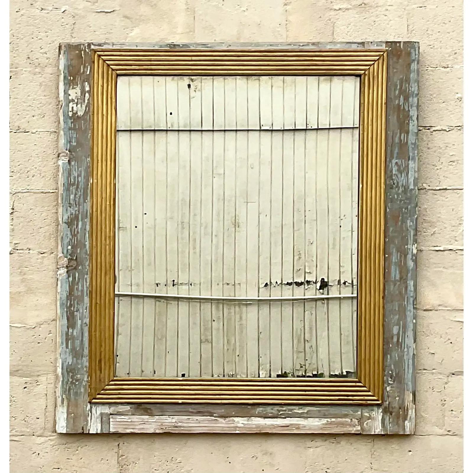 A fantastic vintage Boho wall mirror. One of the most beautiful mirrors I have ever seem. A chic combo of distressed wood and inset carved gilt strips. Acquired from a Palm Beach estate.
