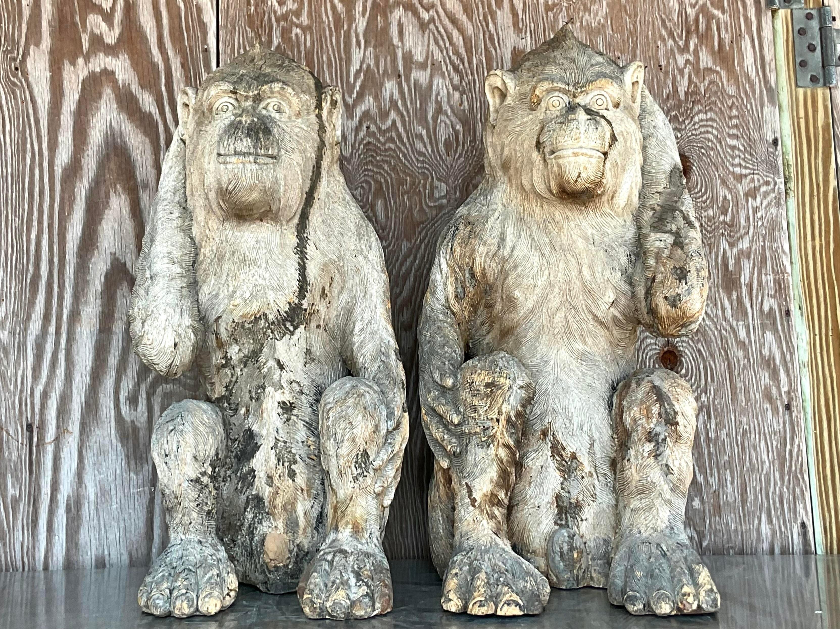 A fabulous pair of monumental wooden carved monkeys. Beautiful detail work with loads of great patina from time. A charming pair sure to add a flash of fun to any space. Acquired from a Palm Beach estate.