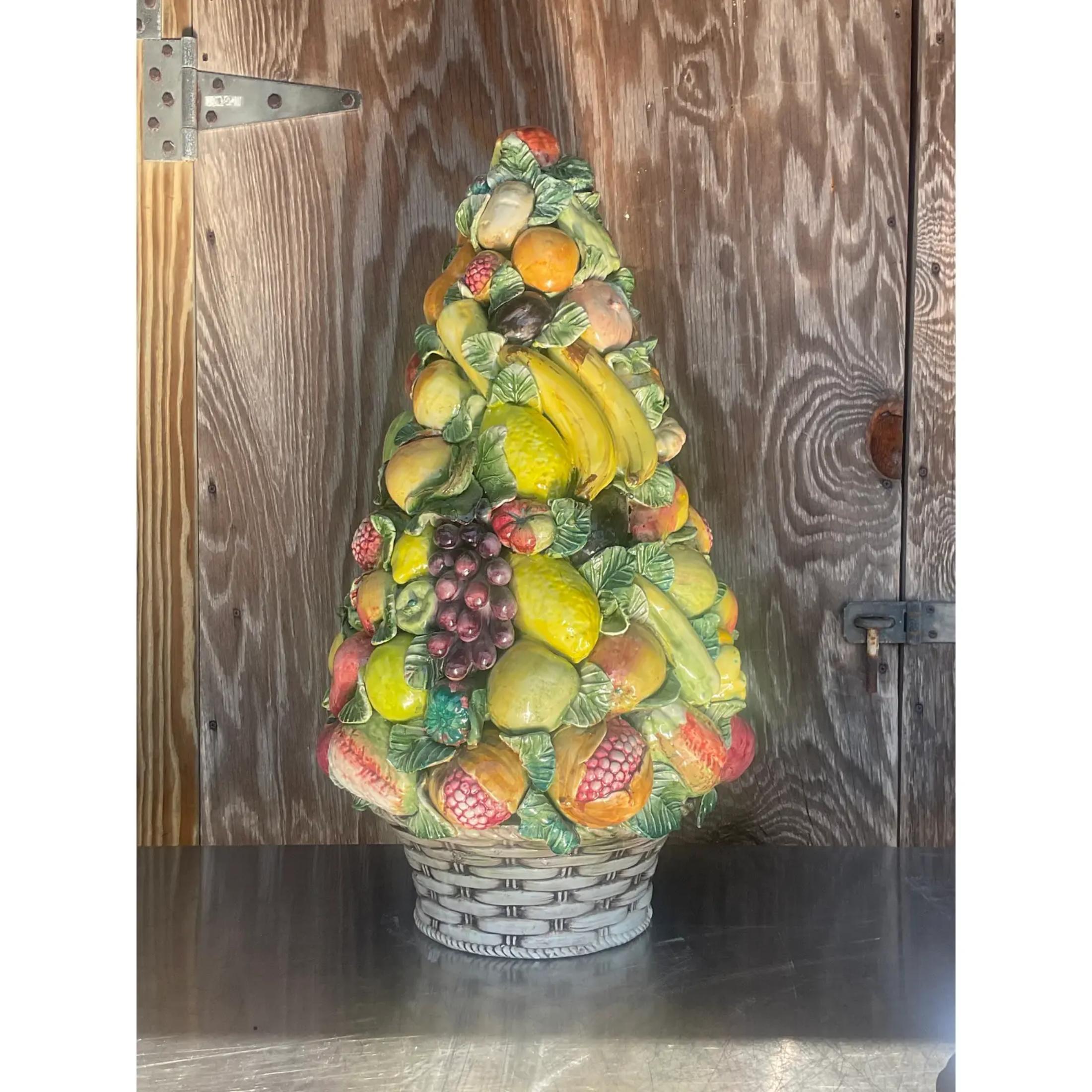 A fantastic monumental Italian fruit topiary. A beautiful stash of hand painted fruit in warm clear colors. Acquired from a Palm Beach estate.