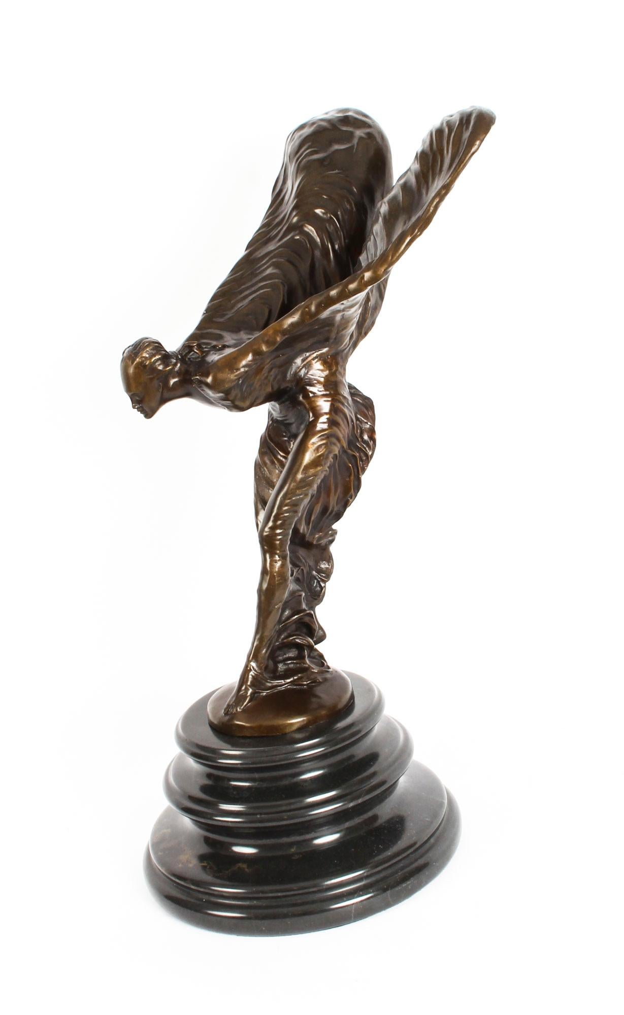 A monumental brown patinated bronze Rolls Royce sculpture of The Spirit of Ecstasy, designed by Charles Robinson Sykes, late 20th century in date.

The sculpture is in the form of a woman leaning forwards with her arms outstretched behind and