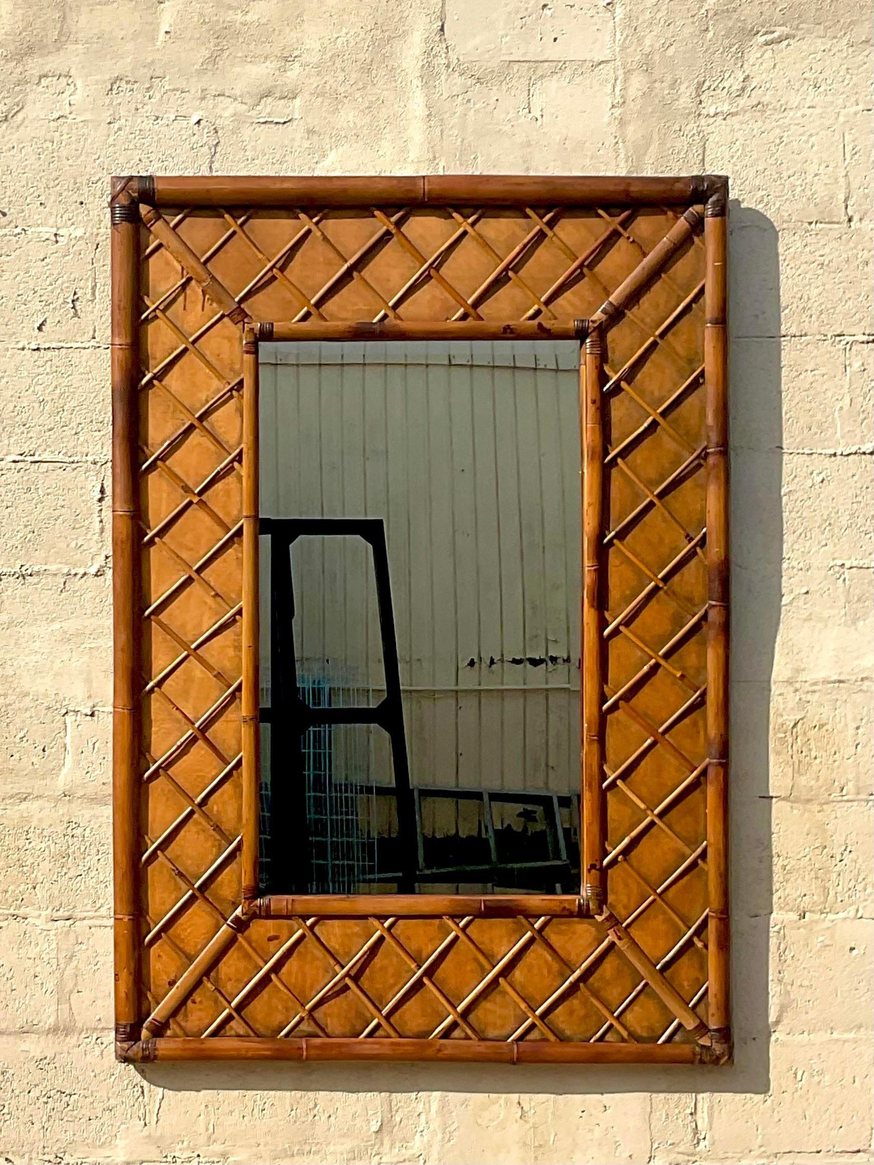 A fabulous vintage Coastal wall mirror. Beautiful thick rattan frame with a border of trellis rattan. Large and impressive. Acquired from a Palm Beach estate.