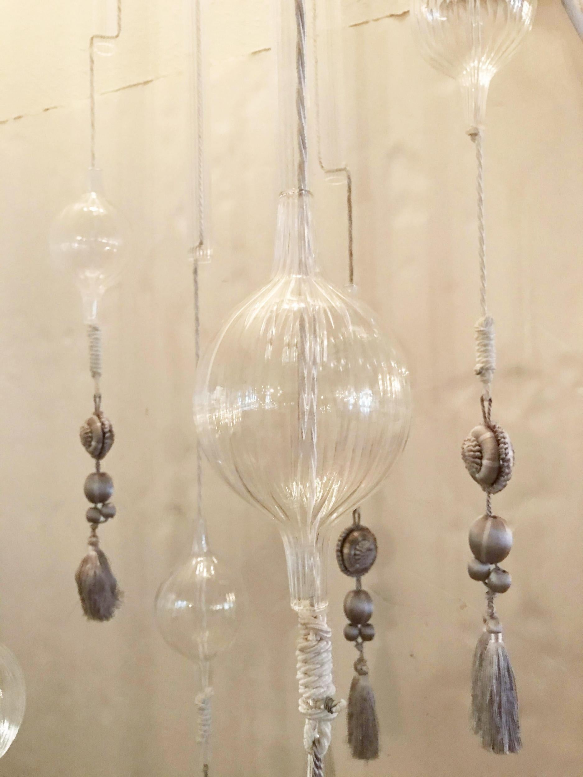 Vintage monumental flushmount chandelier with 9 strands of clear ribbed glass tubes, glass globes and amethyst colored silk tassels, suspended from a circular chrome metal plate, made in Italy, circa 1980s.