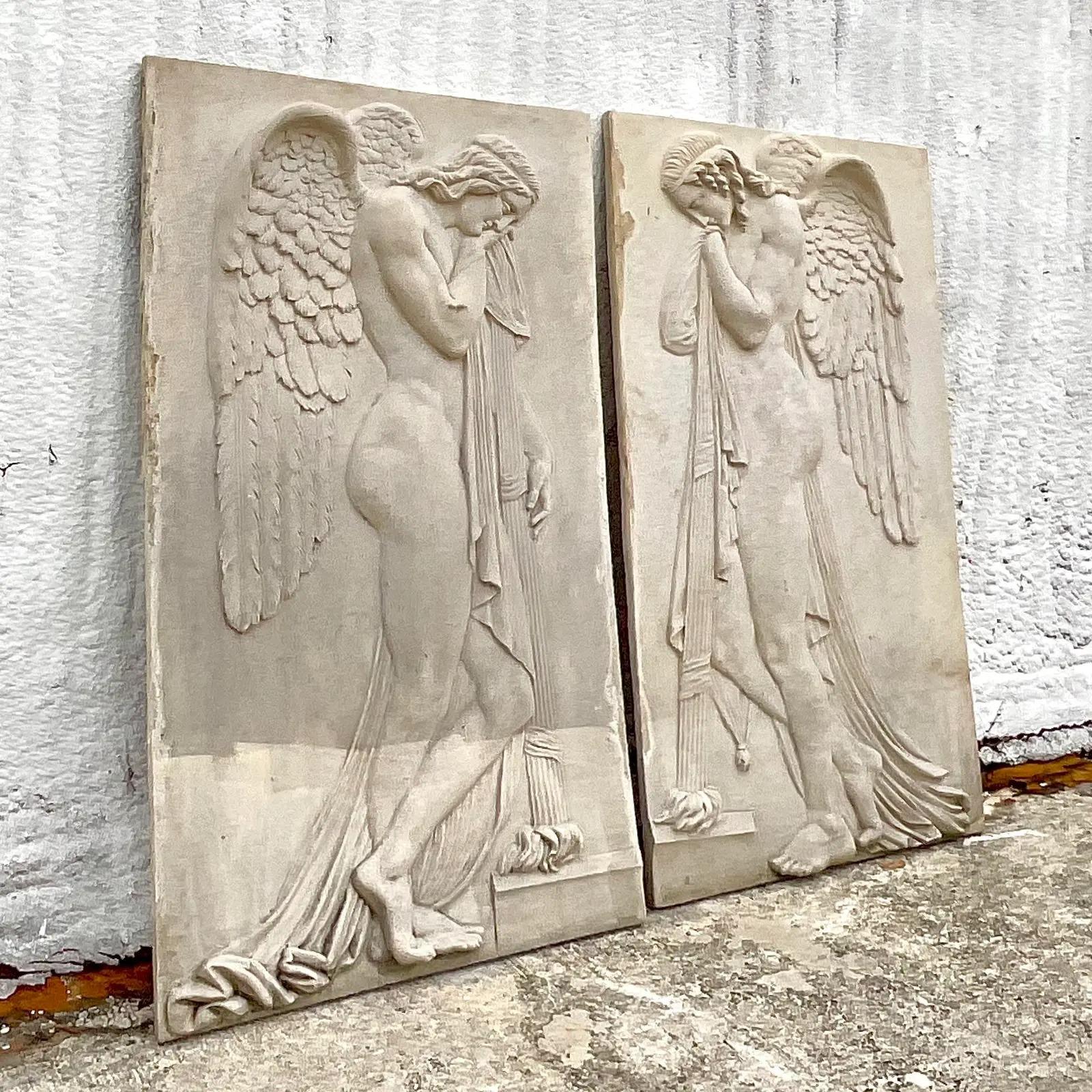 An incredible pair of vintage monumental relief sculptures. Done in the Grand Tour Style with two striking figures in profile. Perfect indoors or poolside. You decide. Acquired from a Palm Beach estate.