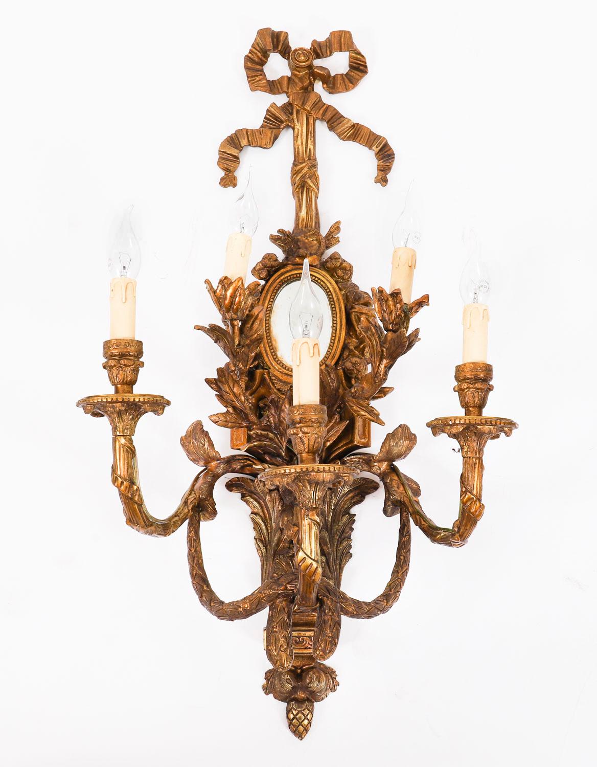 Se trata de una monumental pareja francesa de apliques cuádruples de ormolu dorado del Renacimiento Luis XVI, de mediados del siglo XX.
 
Un gran par de apliques de pared muy ormolu, cada uno con tres brazos en espiral y dos ramas interiores