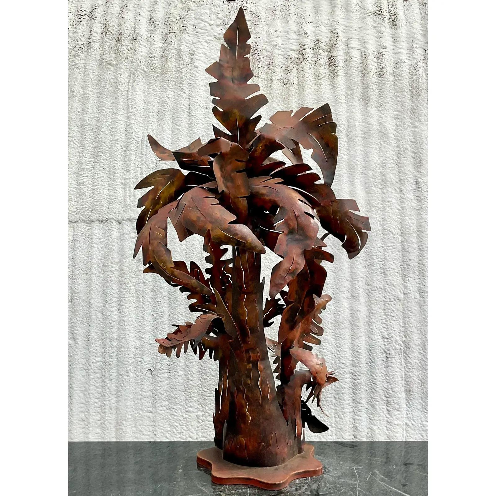 A fantastic vintage Coastal monumental table lamp. A fabulous patinated finish on a punch cut metal palm tree. Large and dramatic and sure to add a little tropical charm to any space. Acquired from a Palm Beach estate.

The palm tree lamp is in