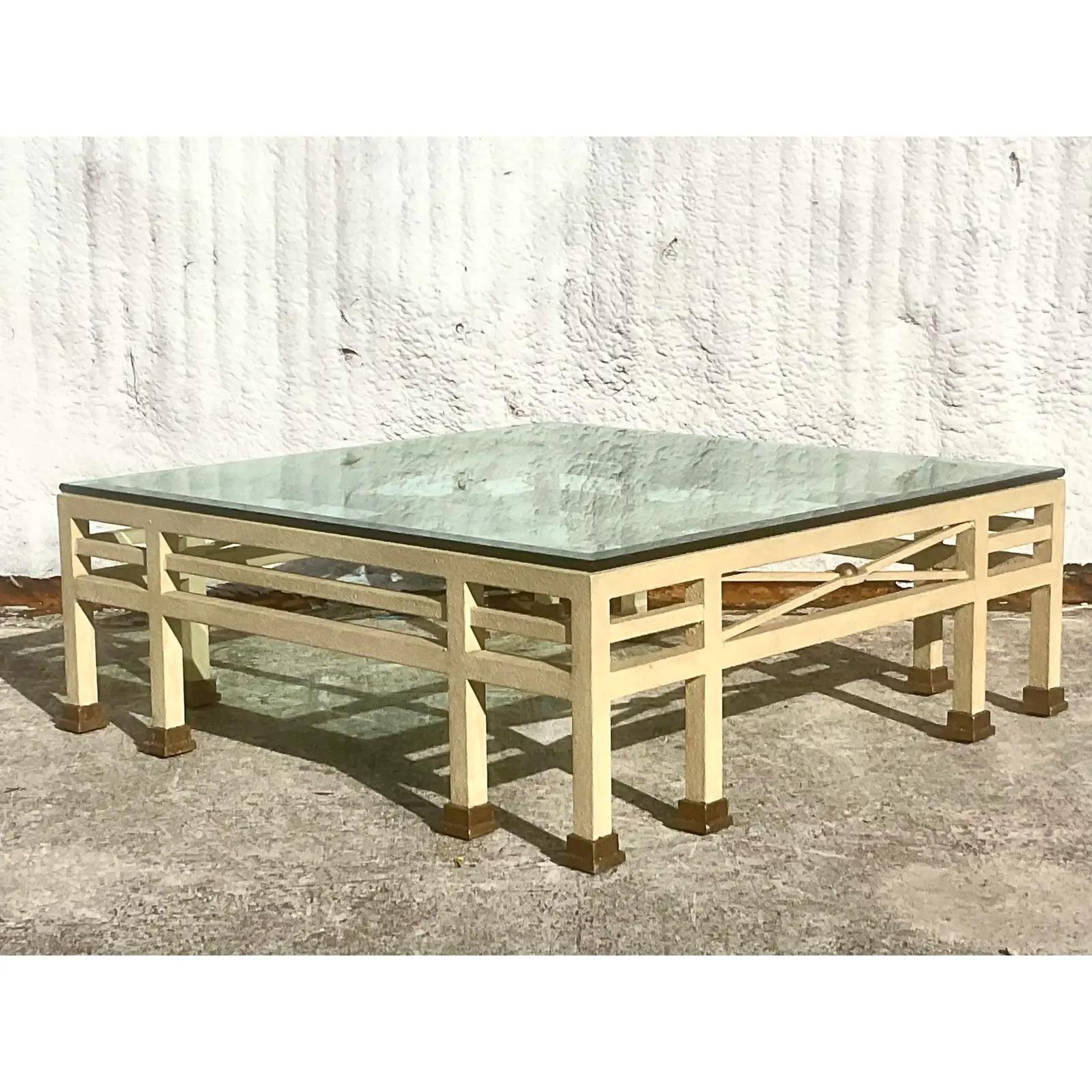 A fantastic monumental vintage coffee table. A chic PostModern design with a textured finish over metal. Thick glass top rests on the frame. Acquired from a Palm Beach estate.