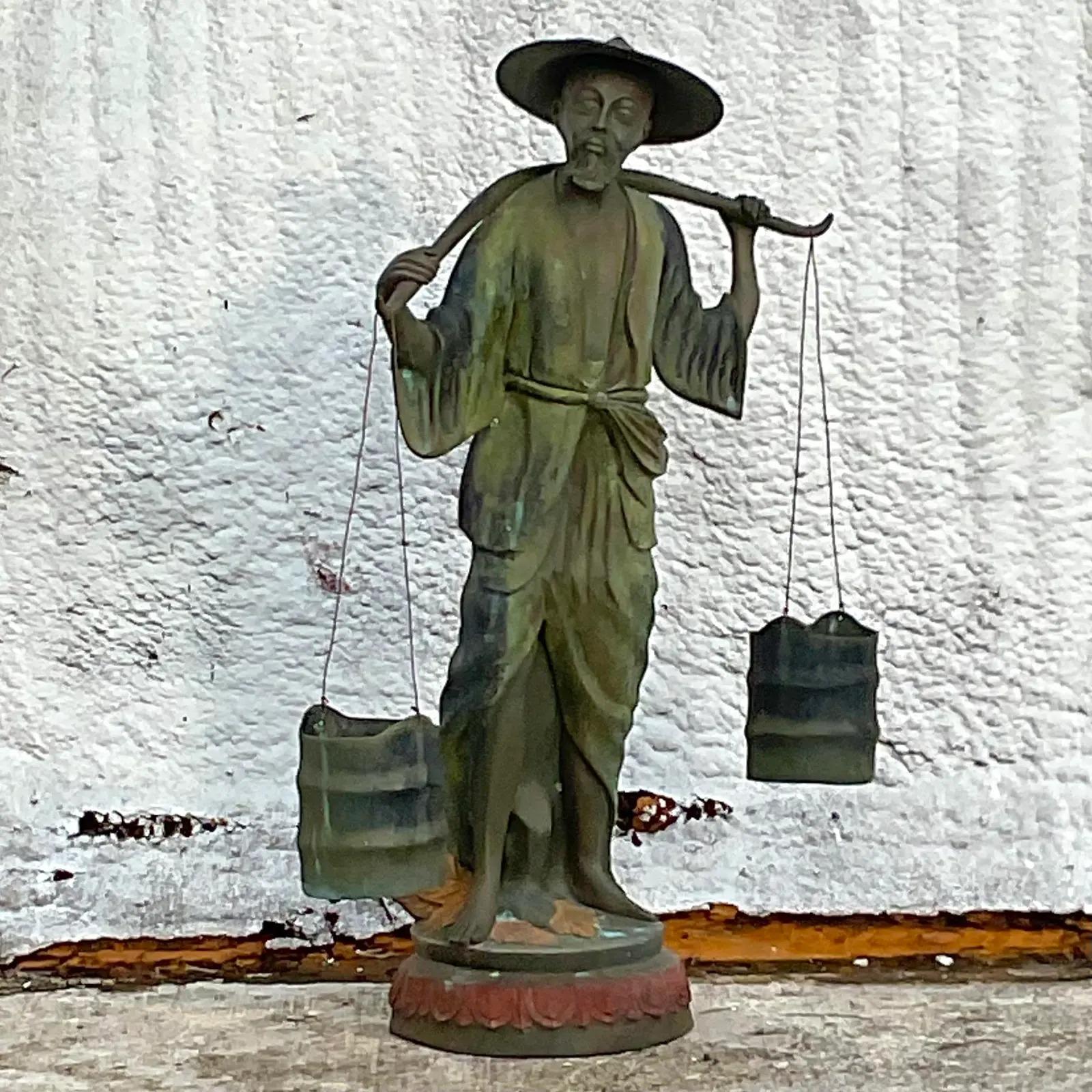 A chic and fantastic vintage Regency bronze sculpture. A striking composition of a man carrying water buckets. Hand painted detail across the bottom of figure. Acquired from a Palm Beach estate.

The sculpture is in great vintage condition. Minor