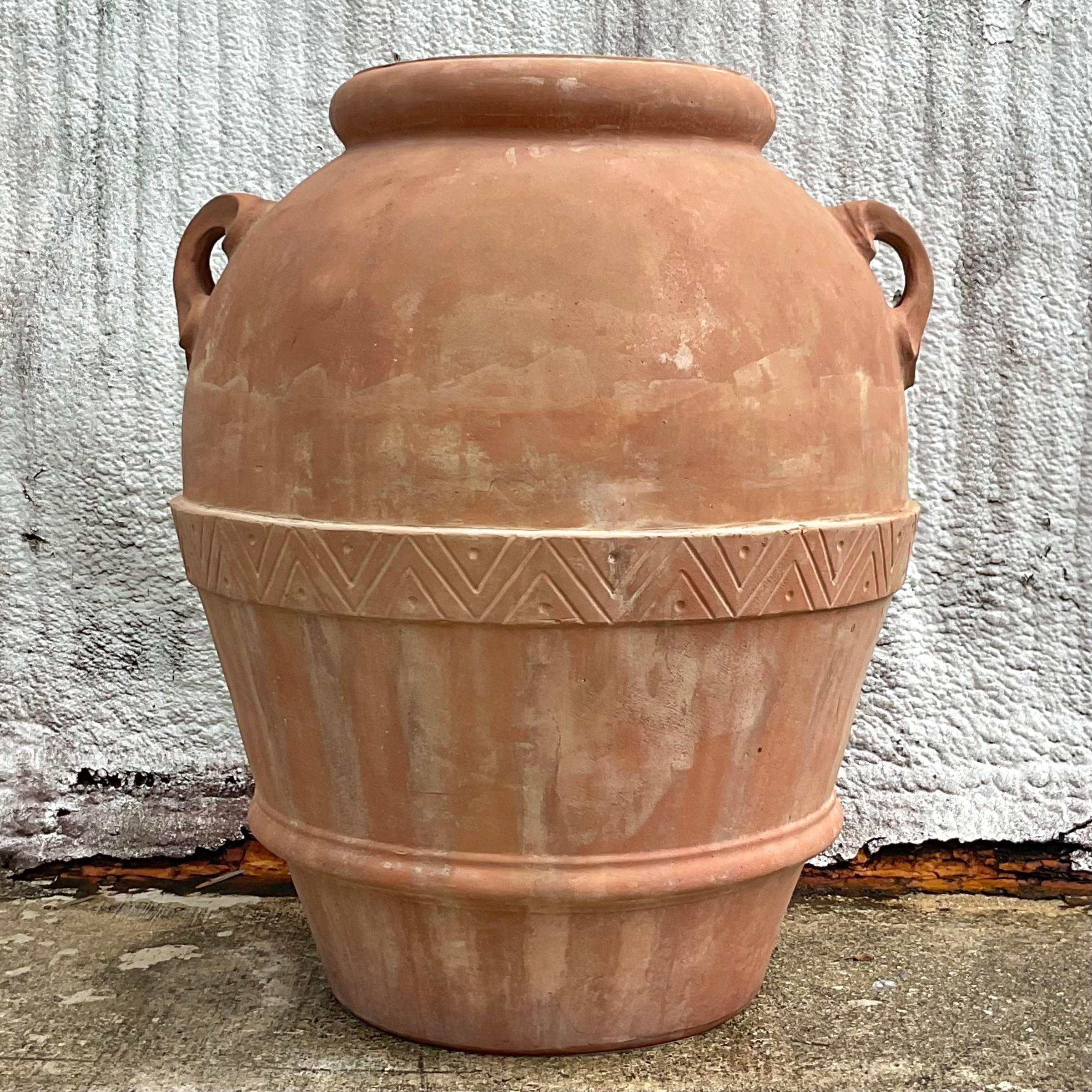 A stunning vintage Boho terracotta urn. Made by the iconic Seibert and Rice group. Monumental in size and drama. Acquired from a Palm Beach estate.