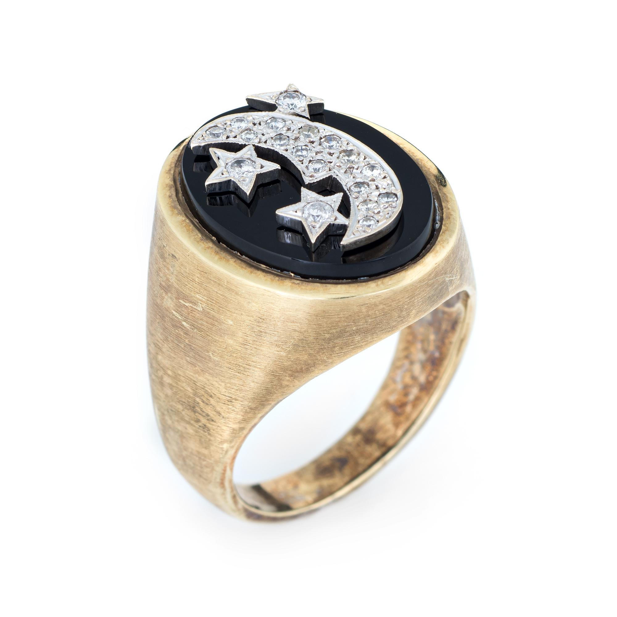 Finely detailed vintage moon & star ring (circa 1970s), crafted in 14 karat yellow gold. 

Round brilliant cut diamonds total an estimated 0.20 carats (estimated at H-I color and VS2-SI1 clarity). The diamonds are set upon an oval black onyx mount