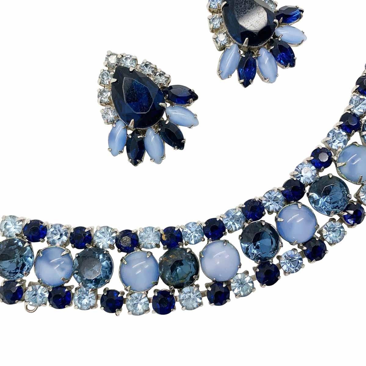 A delightfully feminine moonglow glass bracelet with super stylish matching earrings. Featuring cabochon and marquise cut pale blue moonglow stones with faceted crystal chatons in three shades of blue.

Vintage Condition: Very good without damage or