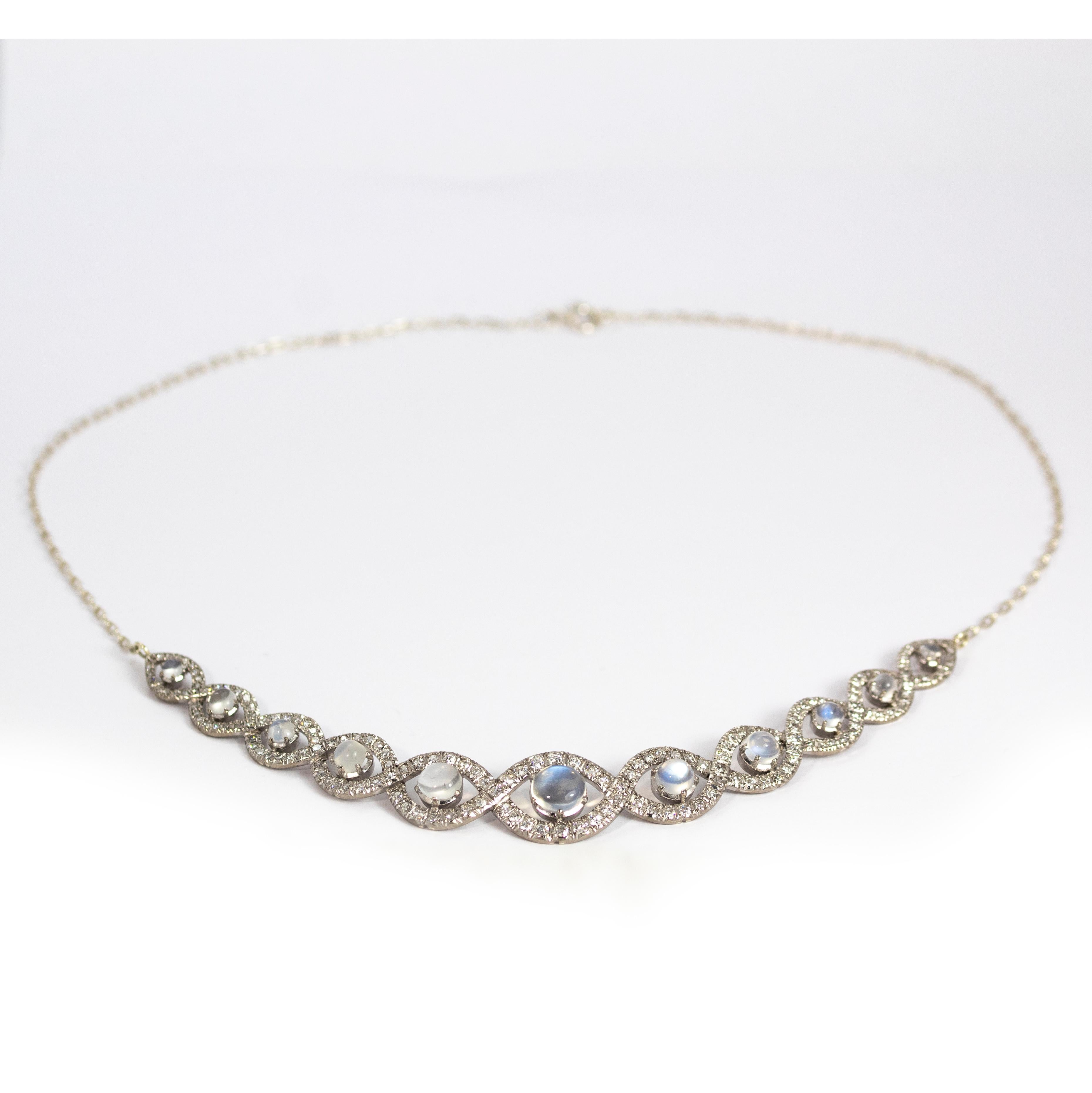 Just take a look at this stunning necklace! The glossy moonstone has a nice blue hue and is set within halos of sparkling diamonds.

Necklace length: chain either side measures 6 1/2 inches, plaque measures 5 inches wide