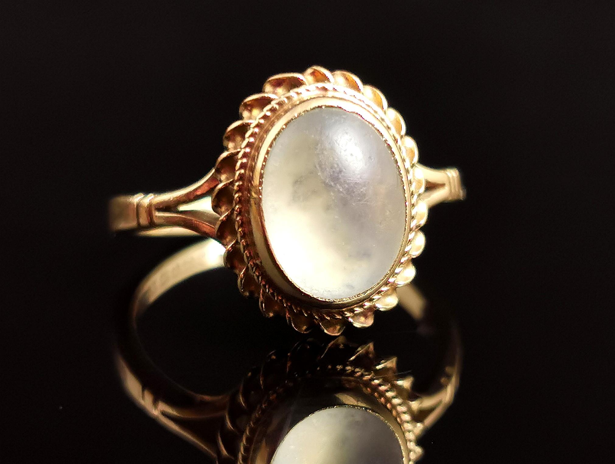 A fantastic vintage, 1970s 9kt yellow gold moonstone cabochon ring.

This ring is all about the centre stone, that beautiful moonstone cabochon, bezel set into the yellow gold setting with a twist and beaded frame.

The stone has some gorgeous tones