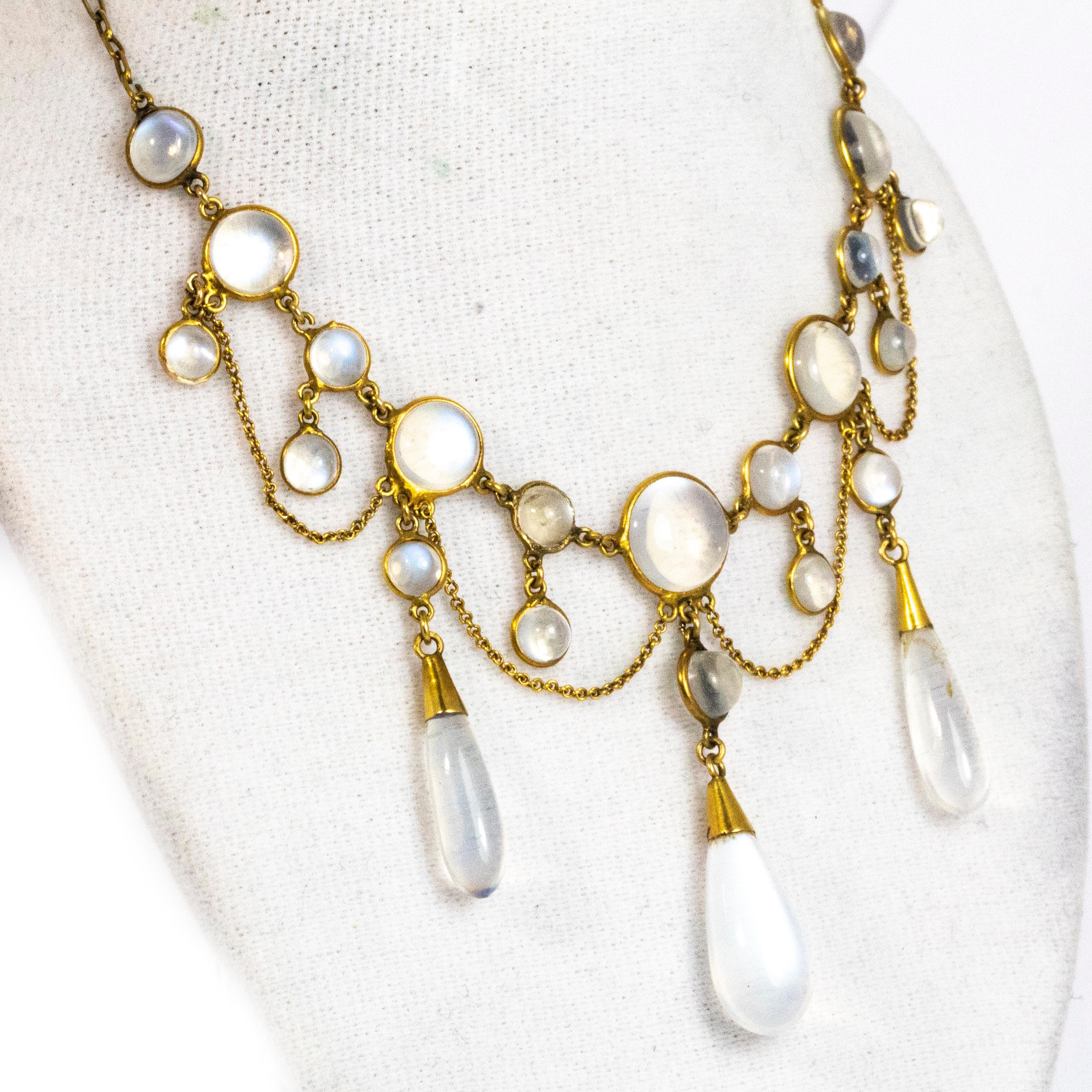 An exquisite vintage festoon necklace. The chain is set with round moonstone cabochons and small drops within the elegant swags. Three stunning long moonstone drops hang from central points giving this piece a wonderful shape. The chain is formed of