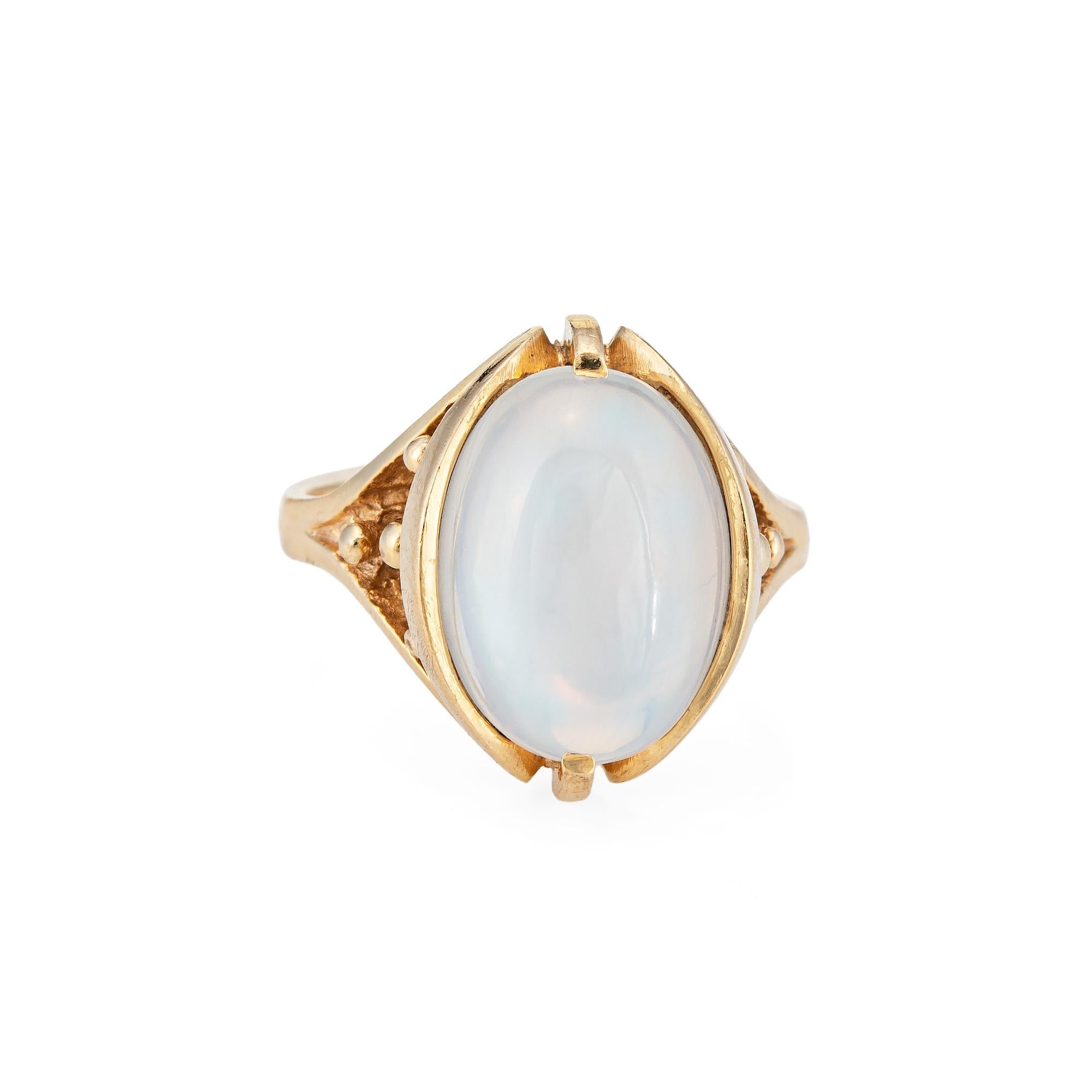 Stylish vintage moonstone cocktail ring (circa 1960s to 1970s) crafted in 10 karat yellow gold. 

Cabochon moonstone measures 13.5mm x 9mm. The moonstone is in very good condition and free of cracks or chips. 

The luminous moonstone glows with