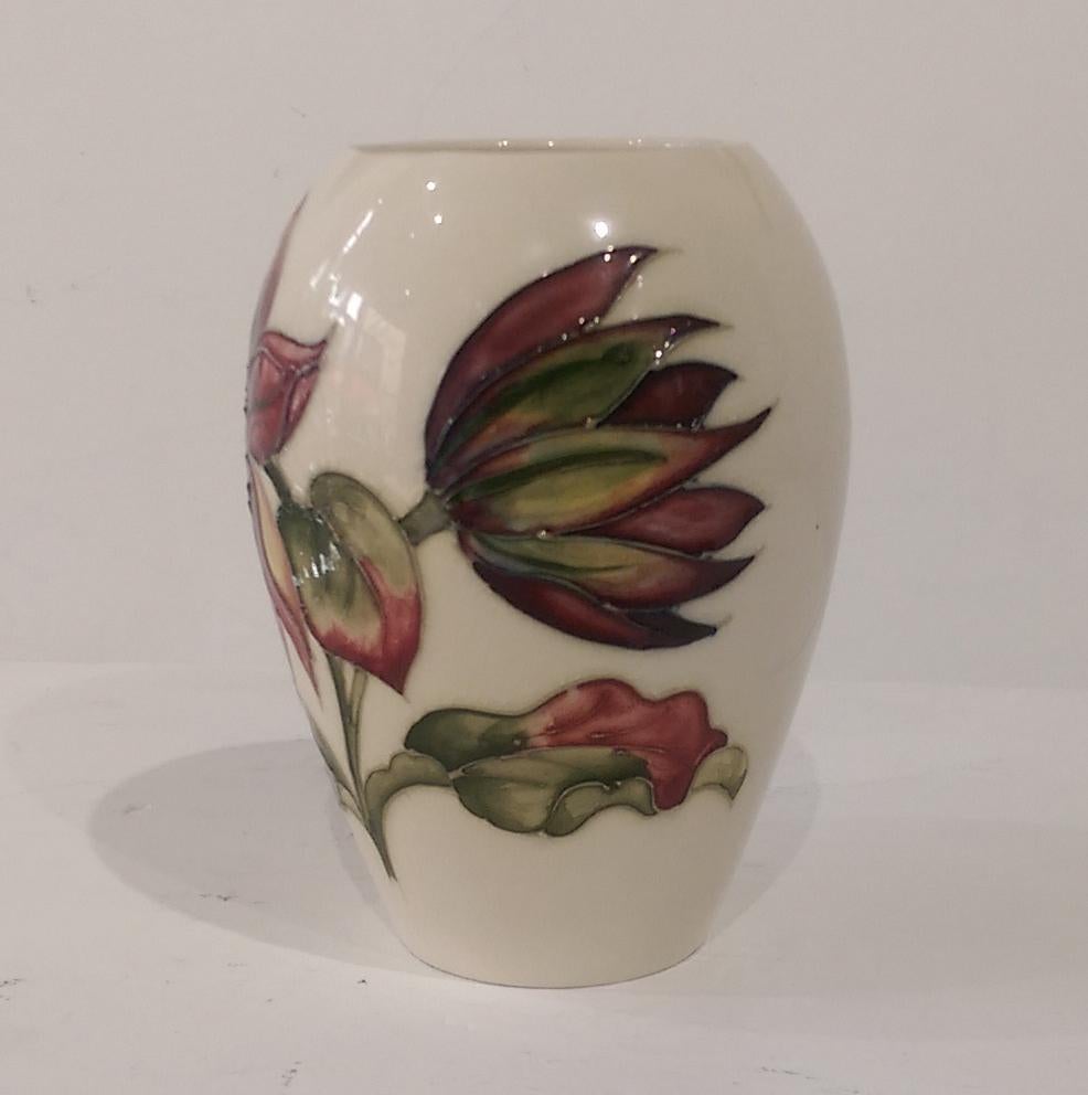 This Stunning Moorcroft Vase is decorated in the much sought after Luscious Clematis Flowers design. The design and colors being very bright and strong; it is the Ovoid form and measures approx. 5.25 inches high x 2.5 - 4 inch Diameter; excellent