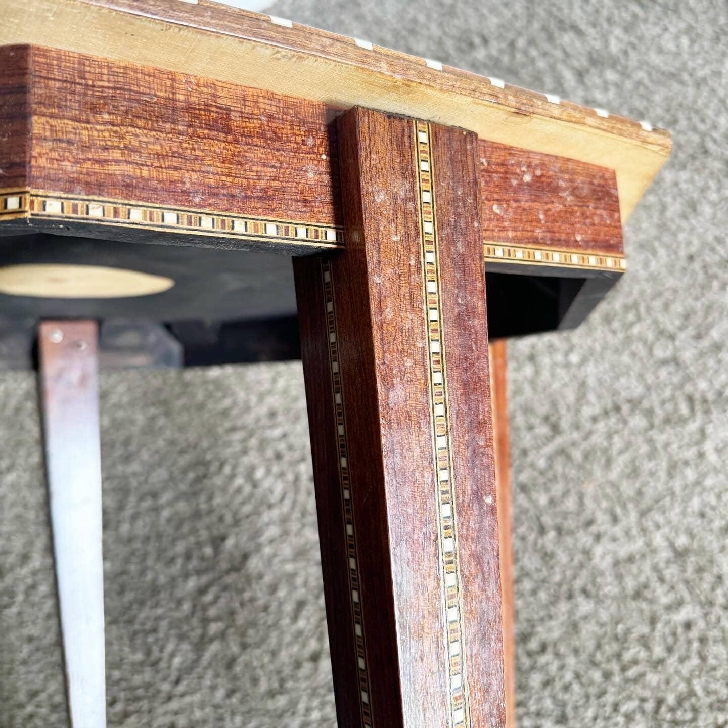 Add a touch of natural elegance to your home with this Vintage Moorish Inlaid Side Table. Featuring intricate geometric patterns and vibrant colors, this hexagonal table showcases traditional Moorish craftsmanship. Perfect as a side table or accent