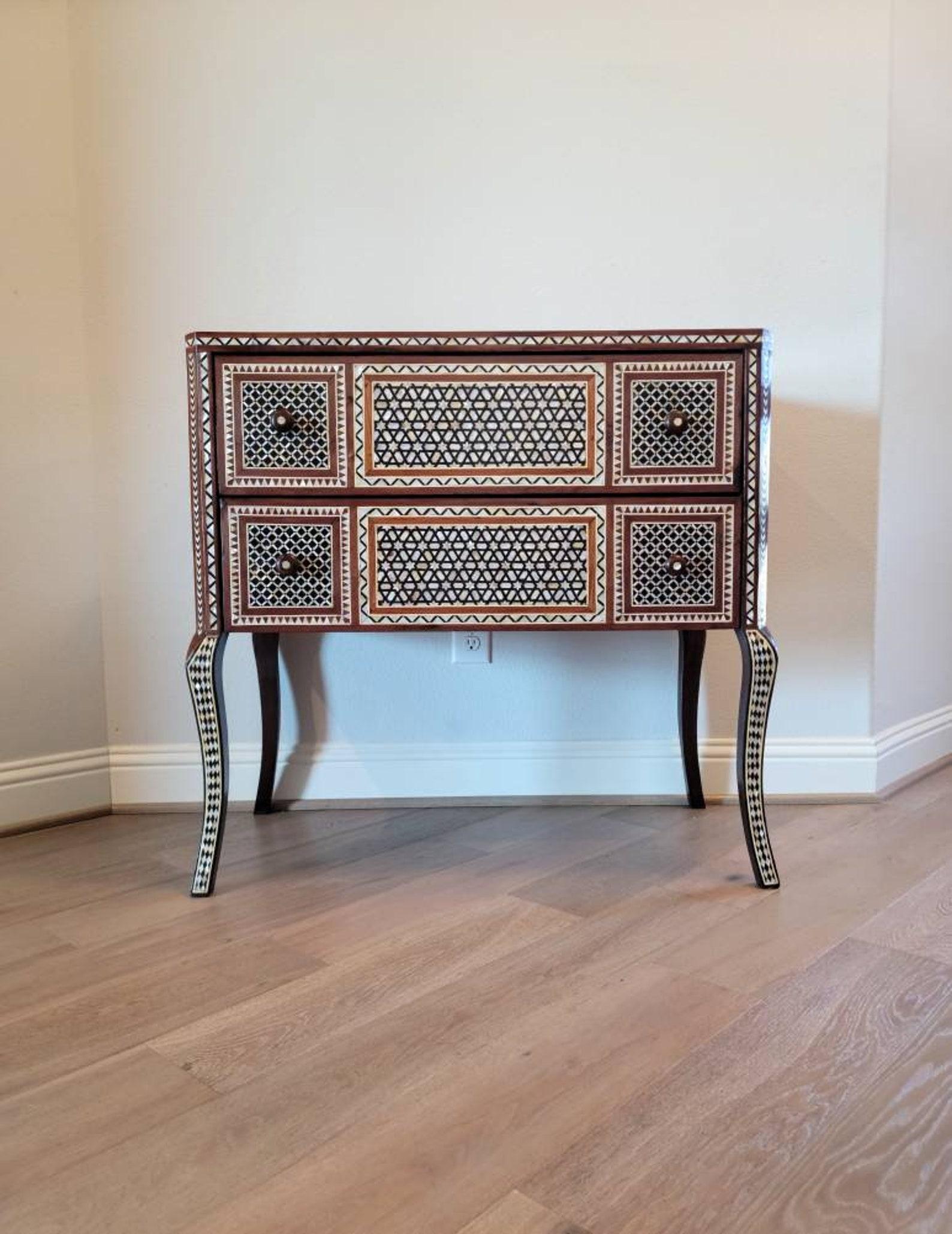 A stunning vintage Middle Eastern Moorish style inlaid chest of drawers.

Exquisitely hand-crafted, featuring mother of pearl, white and ebonized bone, and exotic woods inlay in sophisticated arabesque geometric motif. High-quality solid wooden