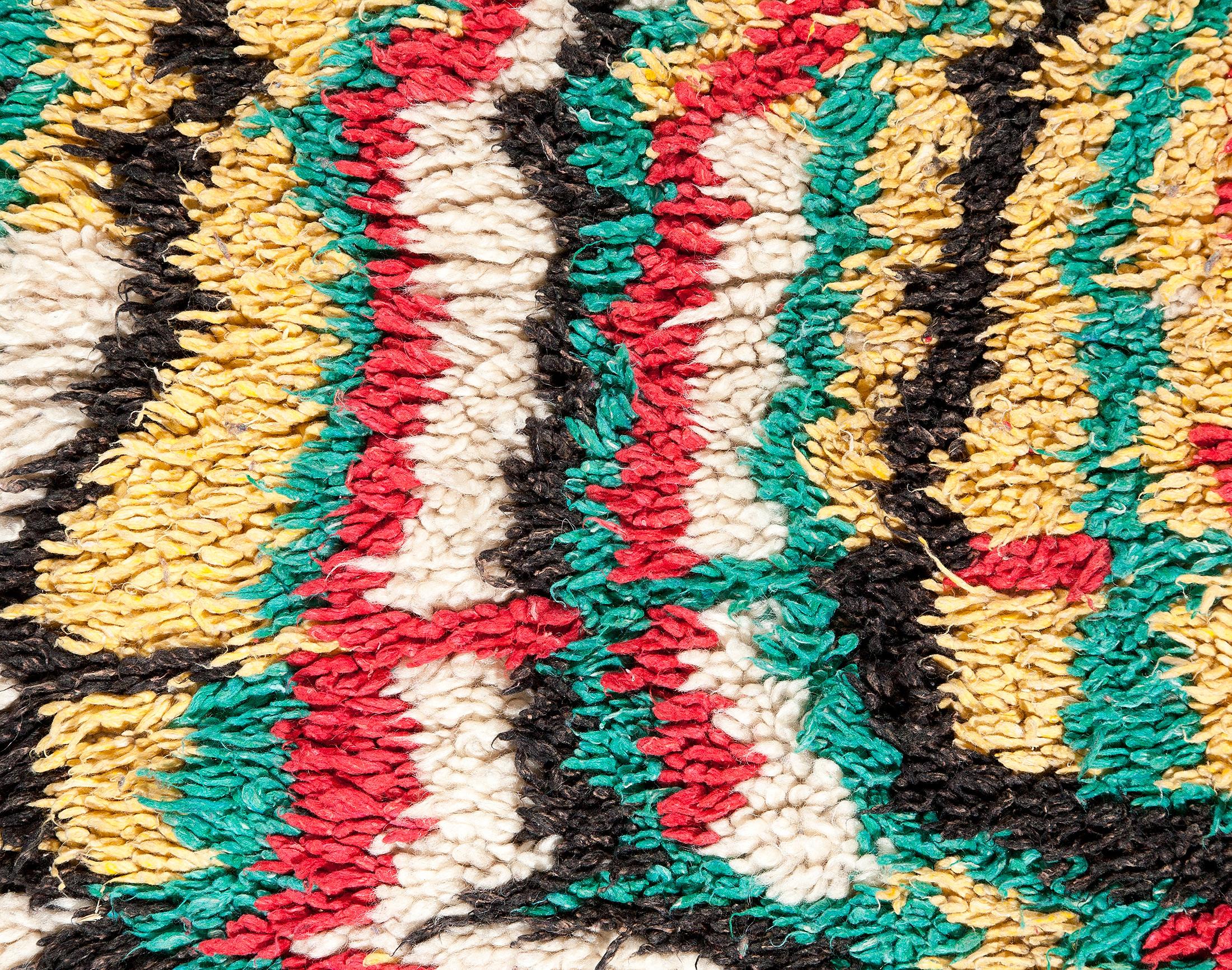Classical Moroccan Berber rug from the Azilal region. Black, red, yellow, blue, green and off-white patterns. Medium-short pile.

This is an authentic Berber carpet from Morocco. In Berber tribes rugs are hand knotted by women in mainly for their