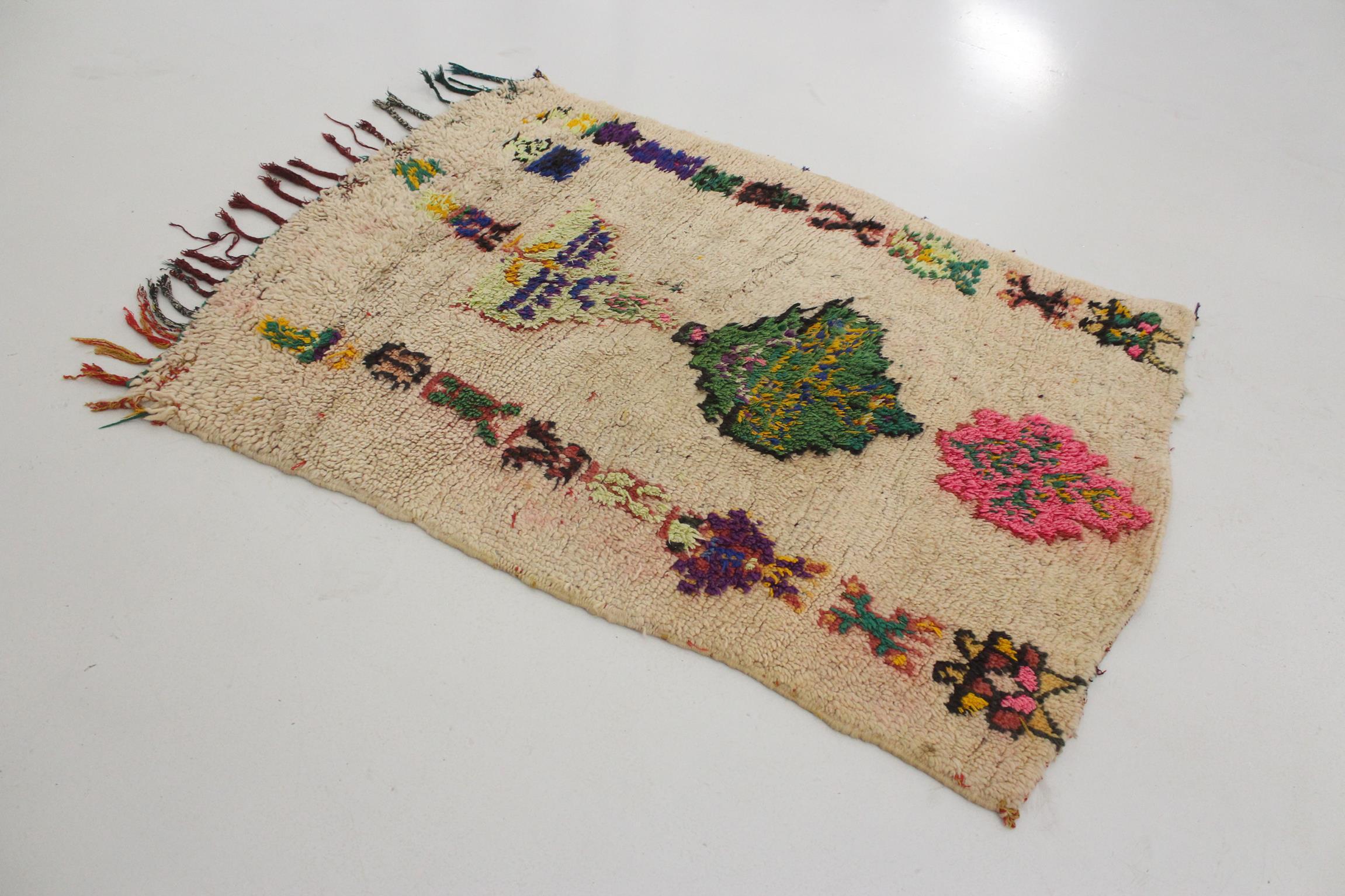I selected this lovely rug from piles of carpets as I have always loved a vintage, artistic Azilal rug with traditional berber designs! The background color of this small rug is a beige (the natural wool color, actually) with unregular, colorful and
