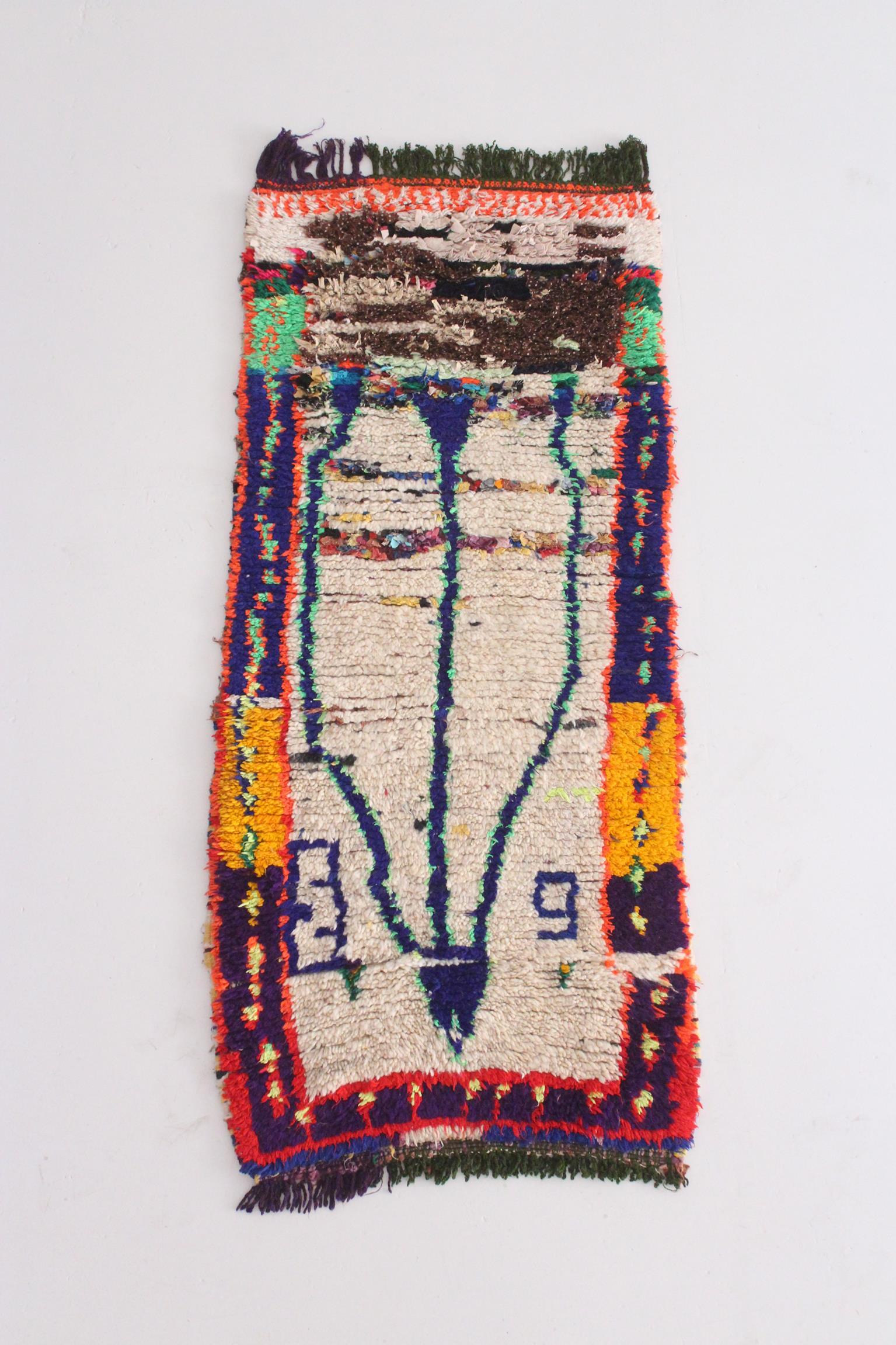 This lovely vintage runner rug has been sourced in the area of Azilal, Morocco. It is made of multiple, colorful cotton threads, recycled pieces of clothes and wool threads knotted together. Women in Morocco have been using this technique for