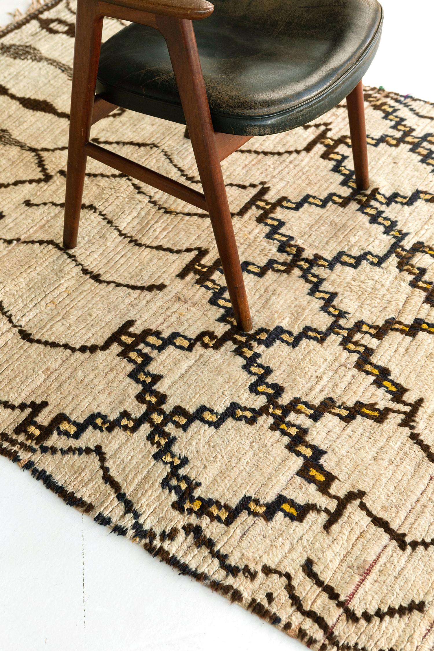 Ivory pile field with pattern elements in dark brown and deep charcoal wools. Large scale motifs including zigzags and stacked diamonds are organized in five horizontal bands, with a sense of symmetry and balance along the vertical axis. Slight