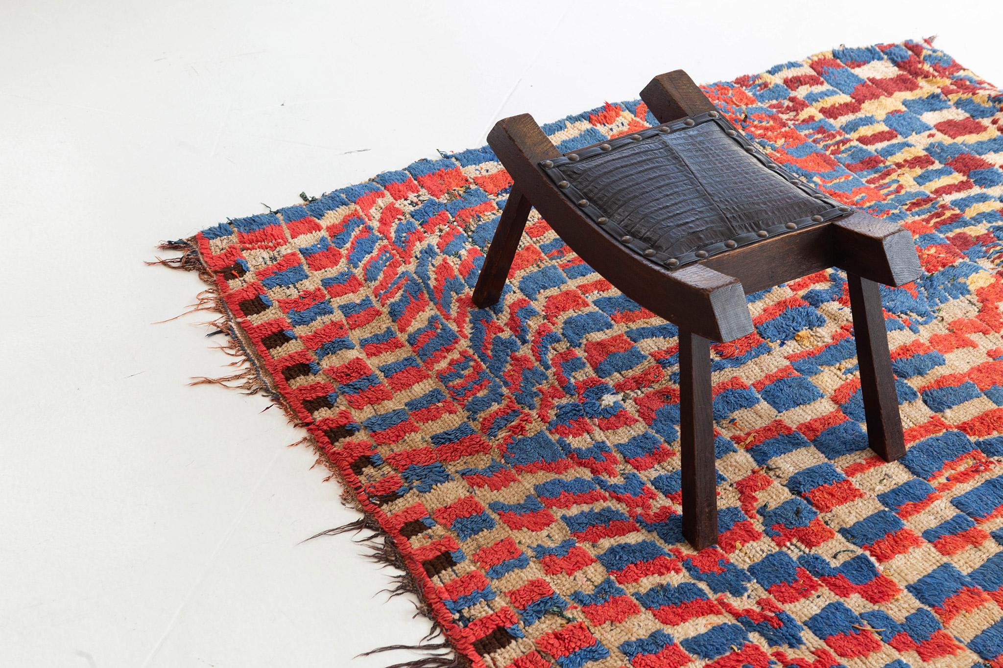 Near-square, eye-catching rug with an unstable checkerboard pattern, combining vivid blue, vermillion, rich brown, tan and pale gold. A vivid vintage tribal piece from the Atlas Mountains of Morocco.