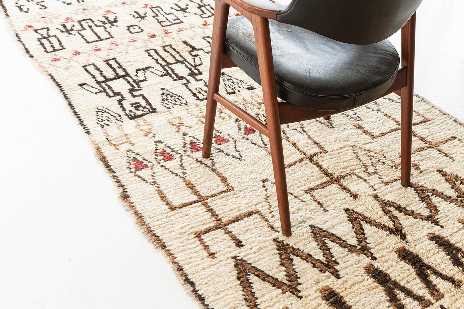 Ivory ground with deep brown, tan, and rose detailed imagery repeating in horizontal bands. Symbolic forms include human figures, numbers, and archaic motifs, all with the legibility of a text, open to interpretation. A unique vintage tribal rug