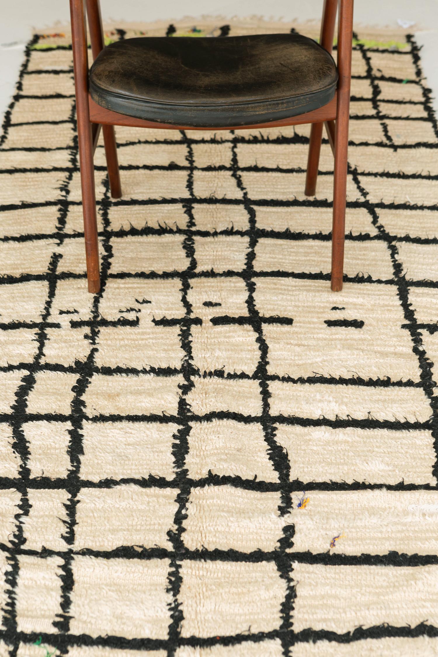 A classy but elegant pile woven rug from Morocco will complete your desired modern-chic bedroom interior. It has an asymmetric square pattern in a dark and light field that will make an eclectic theme. It will be the perfect rug for your bedroom