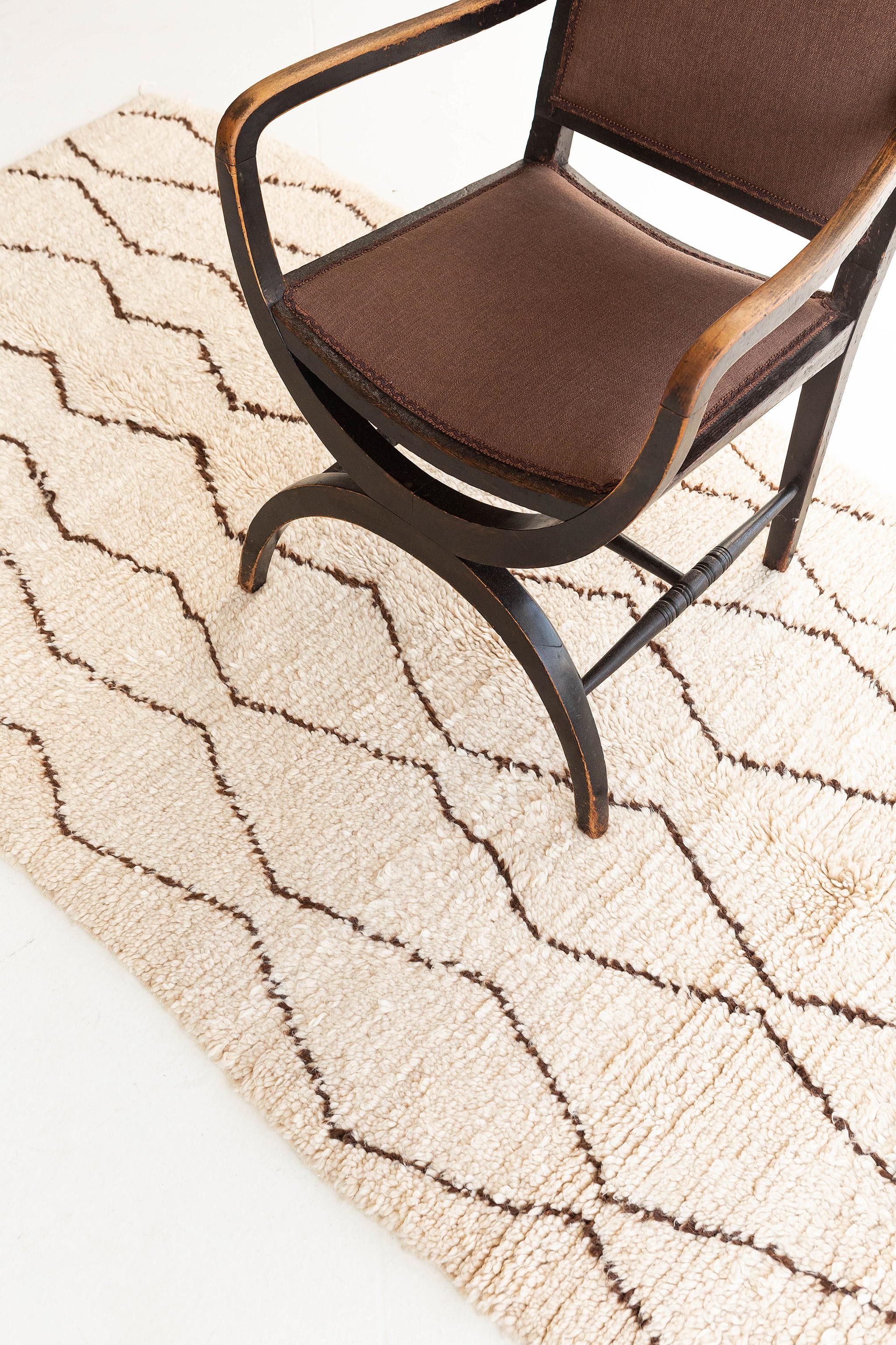 Marking a remarkable effect creating a lozenge scheme, this Moroccan Kilim rug adds texture and modest graphic appeal forming a warm, relaxed space. The field is covered in an outline of detached diamonds across the tantalizing and brilliant