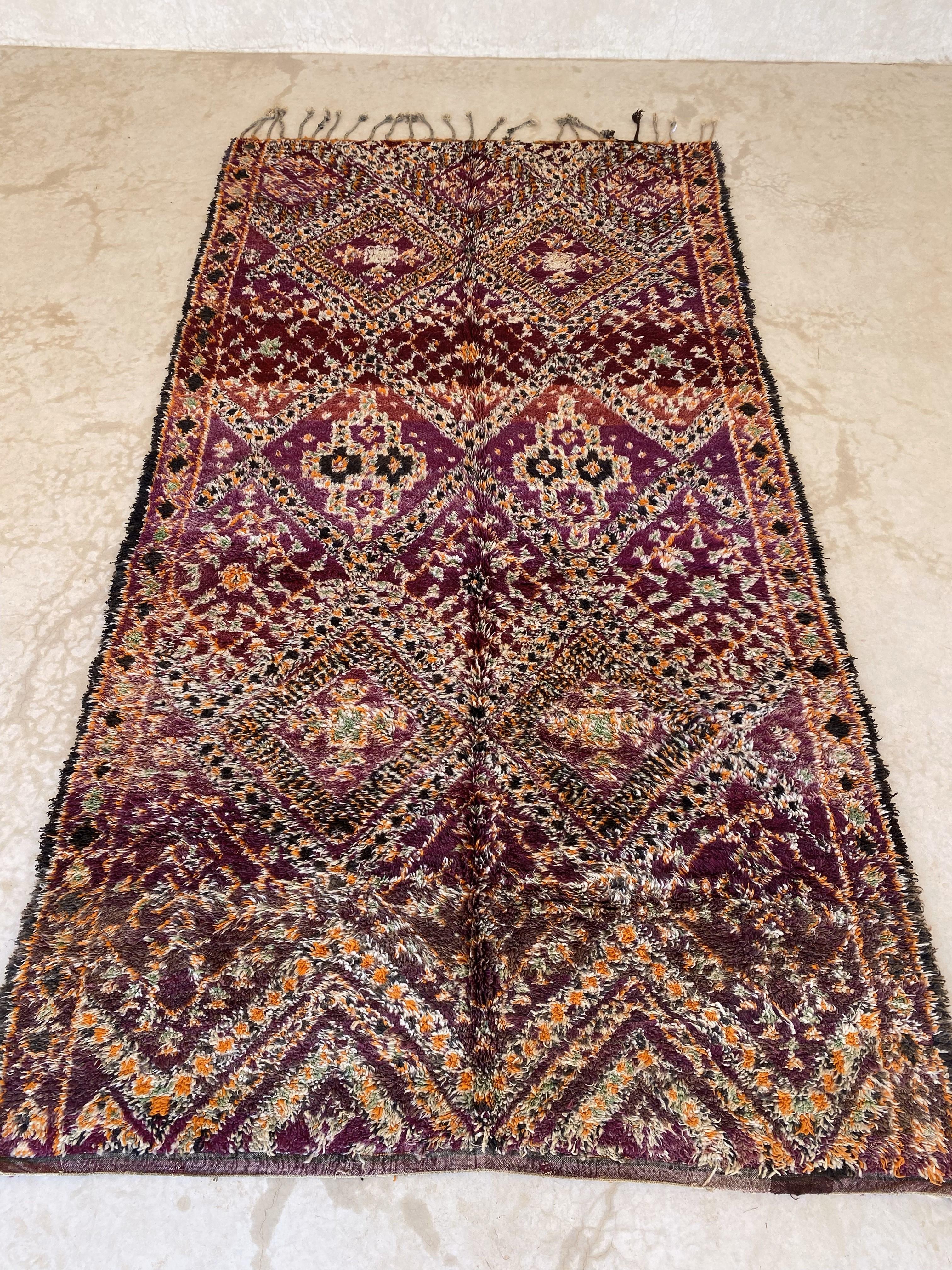 This vintage Beni Mguild rug is gorgeous! The perfect bohemian rug to bring warmth and character to your space!

The background color of this rug is a purple but I guess you can tell from the pictures attached that it shows different shades. The