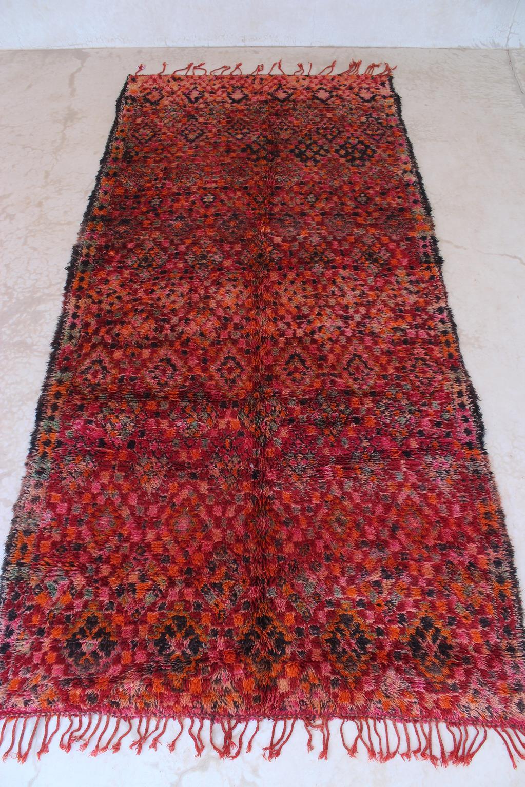 This vintage Beni Mguild rug is gorgeous! The perfect bohemian rug to bring warmth and character to your space!

The background color of this rug is a bright red but I guess you can tell from the pictures attached that it shows different shades. The