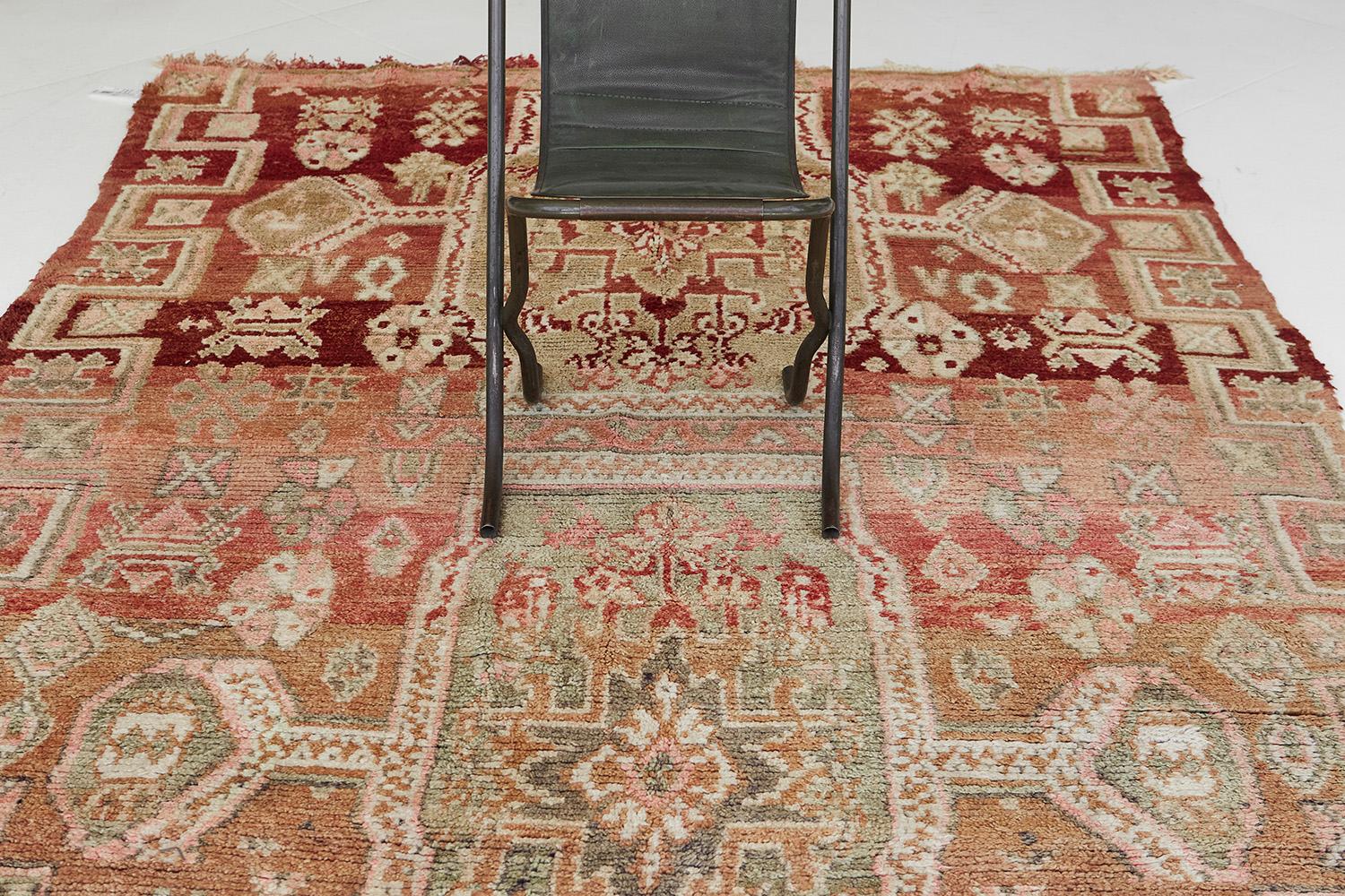 An engaging creation of Beni M'Guild Moroccan rug that features the culture of Moroccan Tribes through ambiguous Berber motifs. Crimson and sage green combinations are perfect for any space with traditional interiors that will accent your home