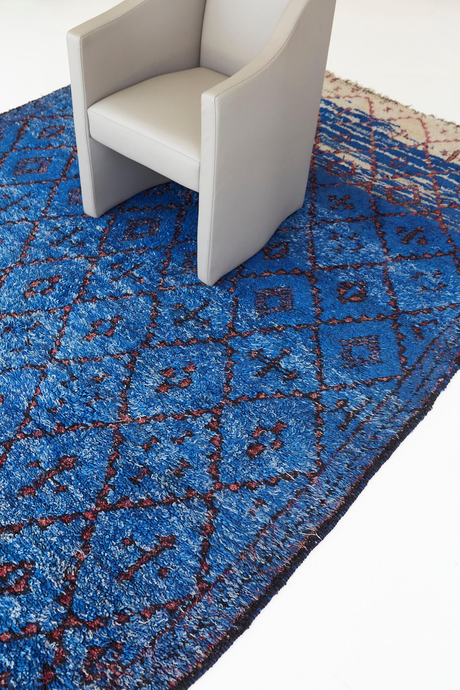 Impresionante alfombra vintage marroquí de la tribu Beni M'Guild, con vibrantes tonos azul celeste y arena. Incorpora estos magníficos paneles de rombos simbólicos con elementos bereberes que recorren el campo rayado. Una pieza estimulante que