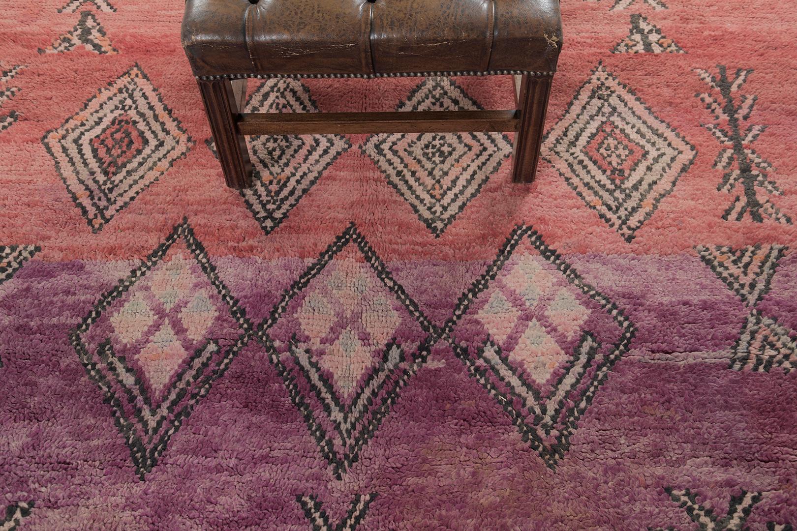Fancy and lively interiors are the ones that can captivate your heart. It makes your room alive together with our classic and one-of-a-kind Beni M'Guild Moroccan Rug. Pigmented purple, peach, and coral are perfectly complemented with all the stories