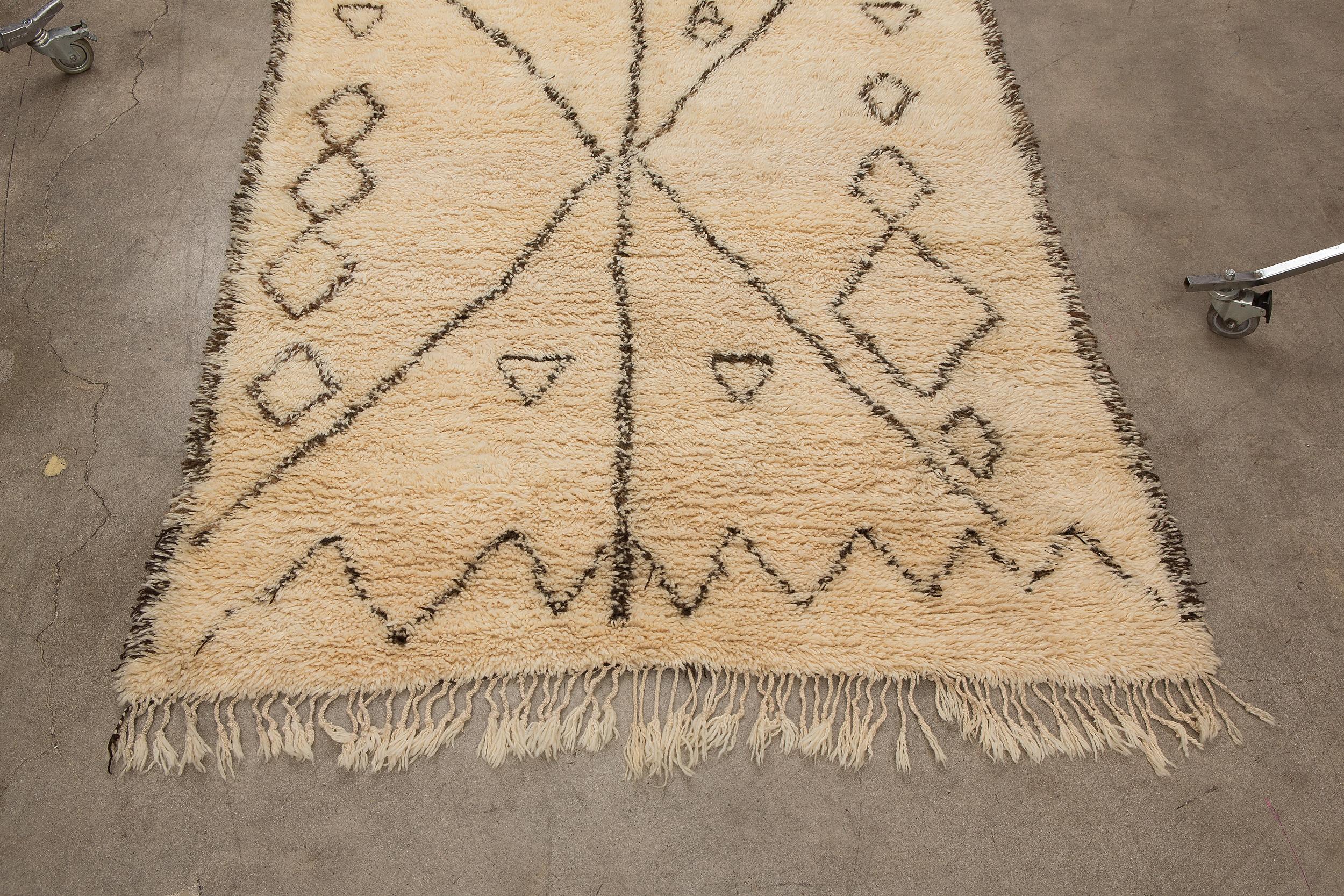 The Beni Ourain tribe resides in the Middle Atlas region of Morocco. Beni Ourain carpets possess a neutral geometric look which blends beautifully with the clean lines of modern furniture and architecture. Labeled 