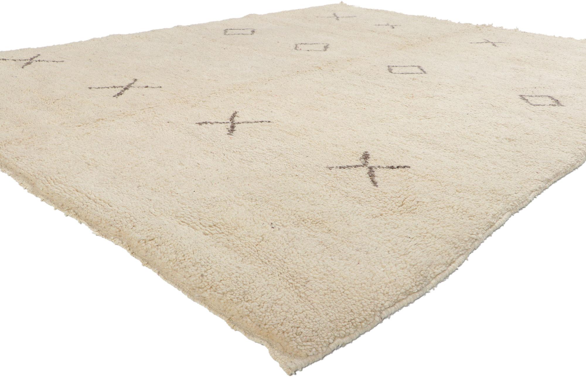 78367 Vintage Moroccan Beni Ourain Rug, 06'10 x 09'02. With its nomadic charm and brutalist connotations, this hand knotted wool vintage Beni Ourain Moroccan rug is a captivating vision of woven beauty. The abrashed beige field features a simple