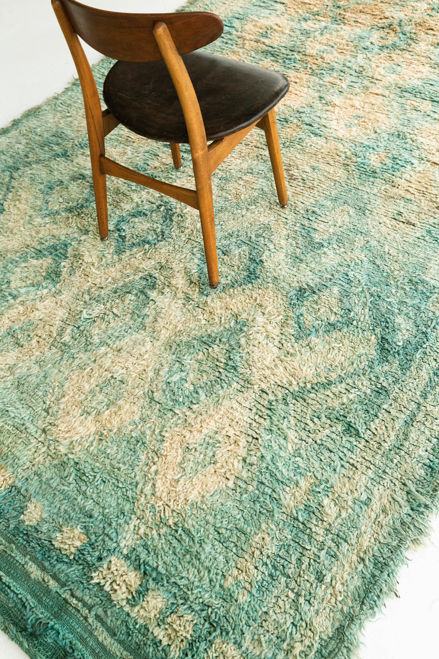 Sea green and yellow wool pile weave handwoven into a one of a kind Moroccan Beni Ourain tribe Berber rug. This piece contains traditional diamond motifs latticed throughout the field. Beni Ourain tribal rugs are known for their geometric patterns