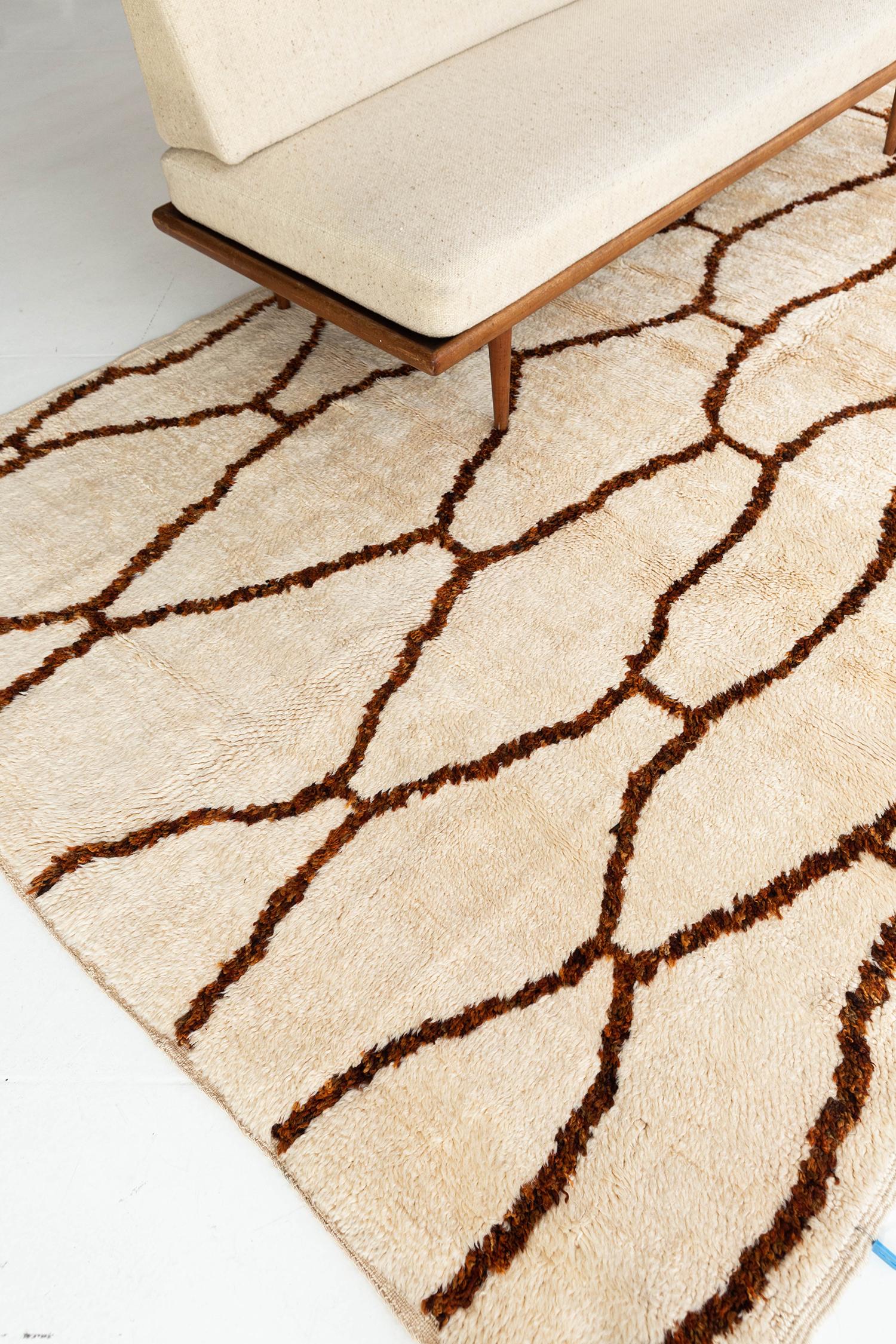 A vintage Moroccan Beni Ourain in the perfect ivory adorned with rustic brown lines creating organic shapes. The rug's handwoven shag texture adds to the rug's overall excitement and makes for a perfect contemporary. This rug will add character to