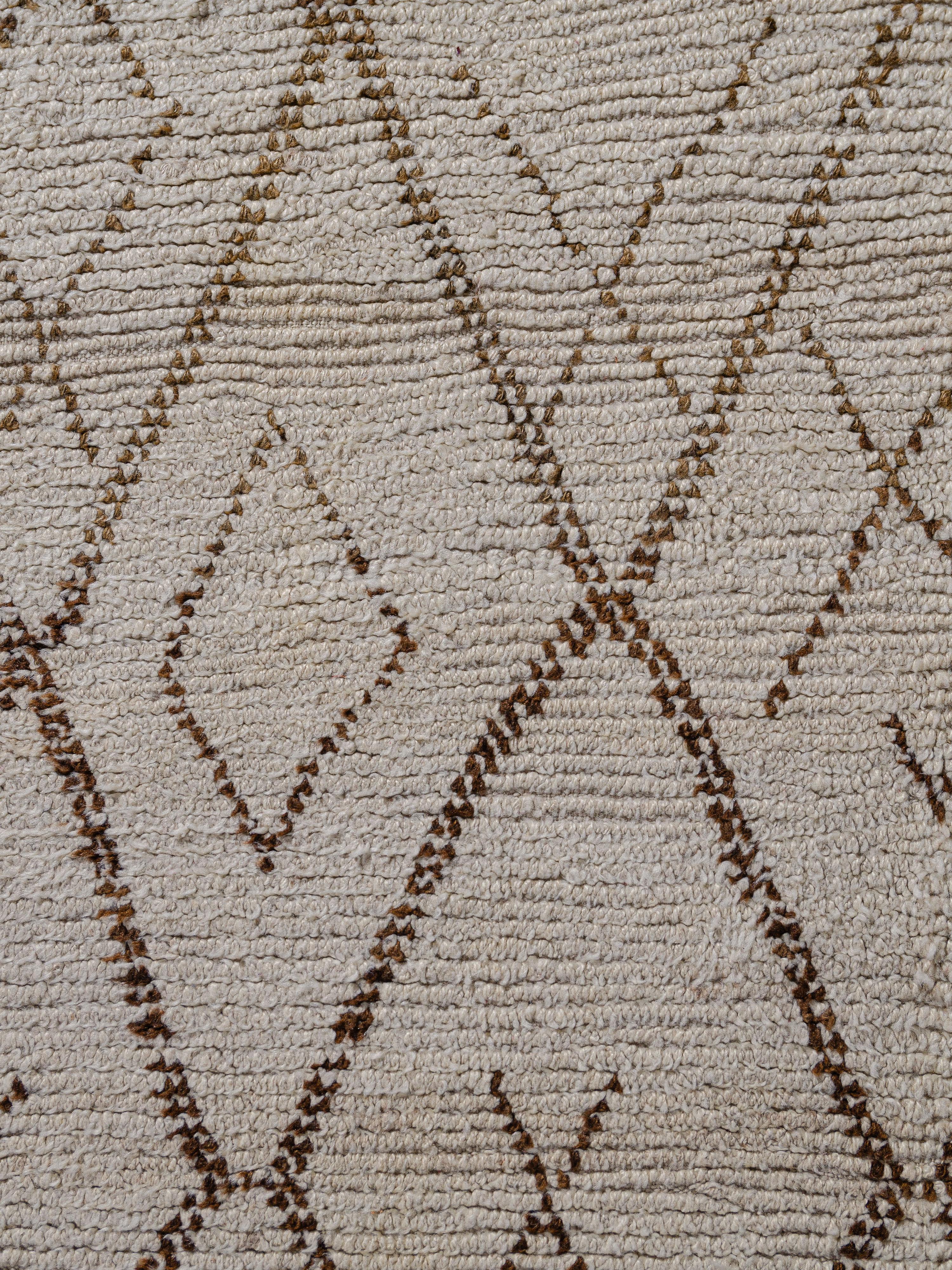 Full of character with its asymmetry and unusual proportions, this vintage Beni Ouarain carpet exemplifies the spirit of handcraft found in Berber arts. The large feminine central lozenge motifs are flanked by an offset male branch forming a moment
