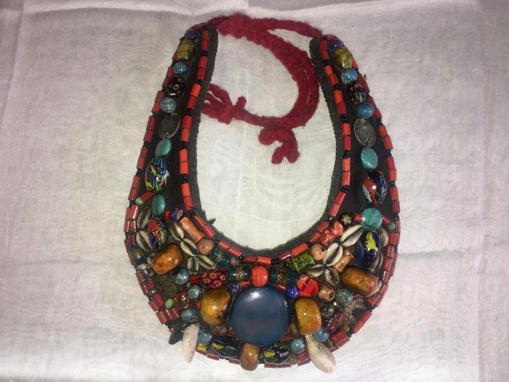 A beautiful Moroccan Berber collar necklace worn for wedding and celebrations. This spectacular piece dates from the early 1950s. Backed by hand-dyed Tuareg leather hand-decorated with traditional geometric designs, the wide collar is adorned with