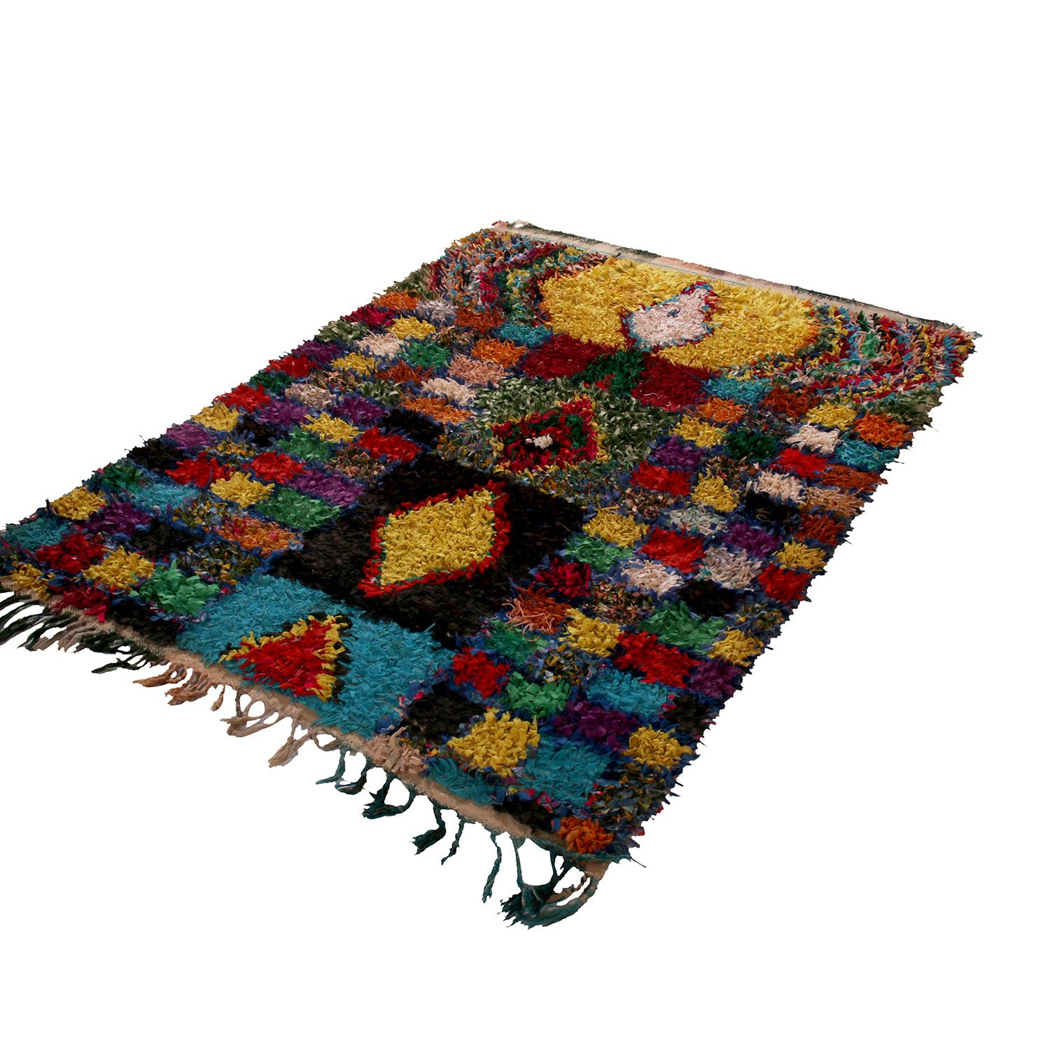 Hand knotted in textural, durable fabric originating between 1950-1960, this vintage Moroccan Berber rug enjoys a warm transitional marriage of lively color and pattern. The shag texture of the fabric pile beautifully complements the play of vibrant